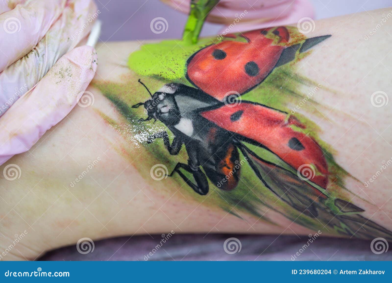 Premium Photo | Black and white ladybug tattoo on the upper back.