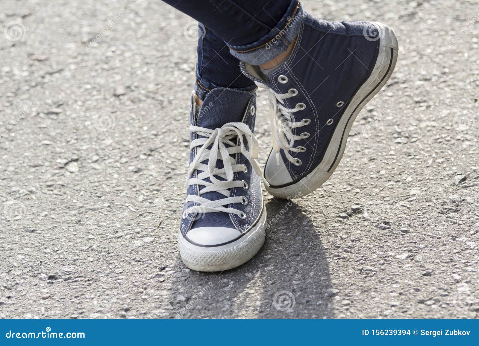 Women`s Feet in Sneakers are Standing on the Sidewalk Stock Photo ...