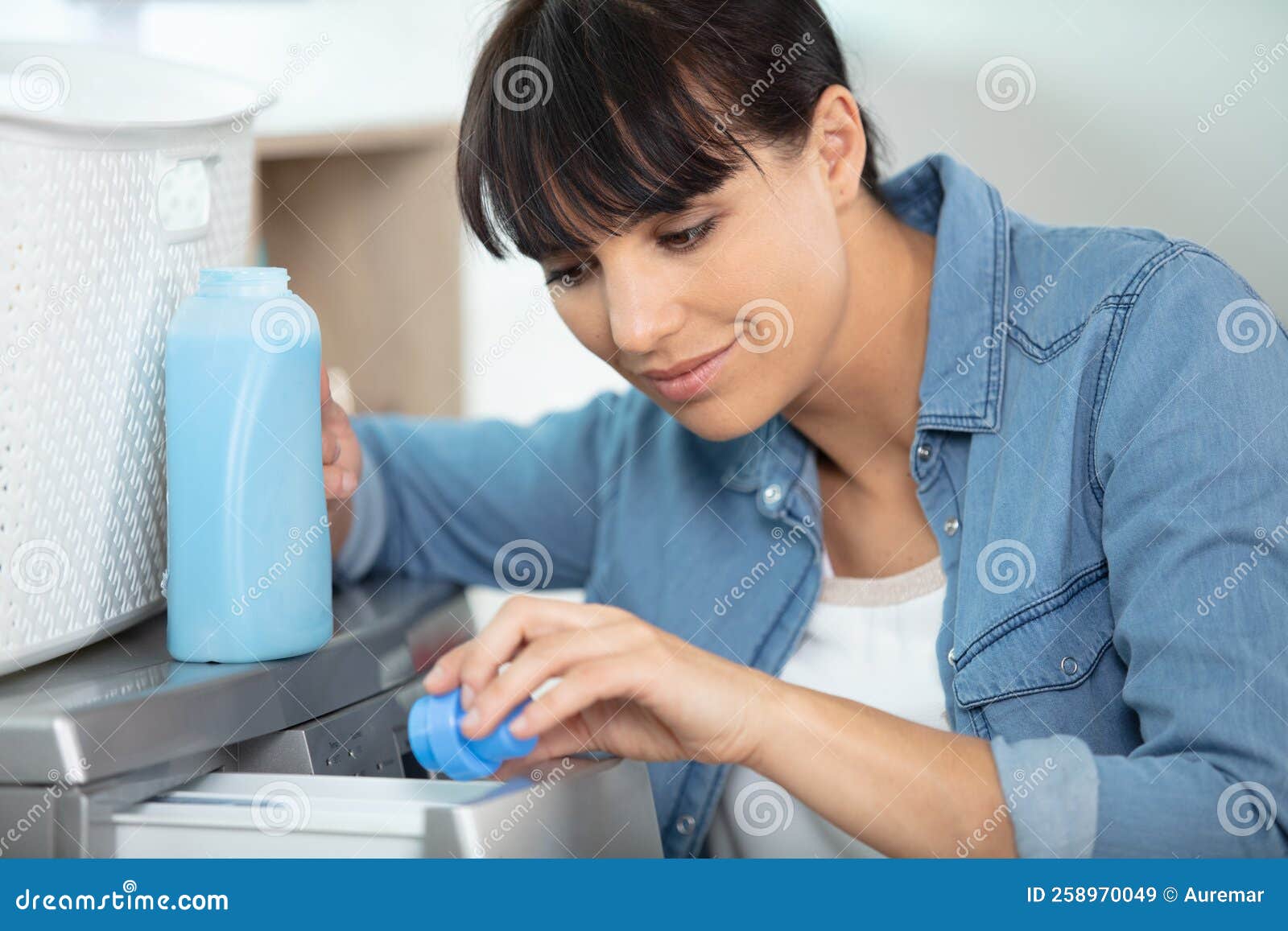 Closeup Female Hands Pouring Detergent in Washing Machine Stock Image