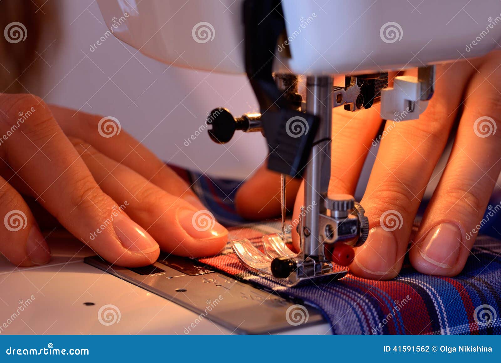 Closeup Female Hands Sewing Fabric on Sewing Machine Stock Photo