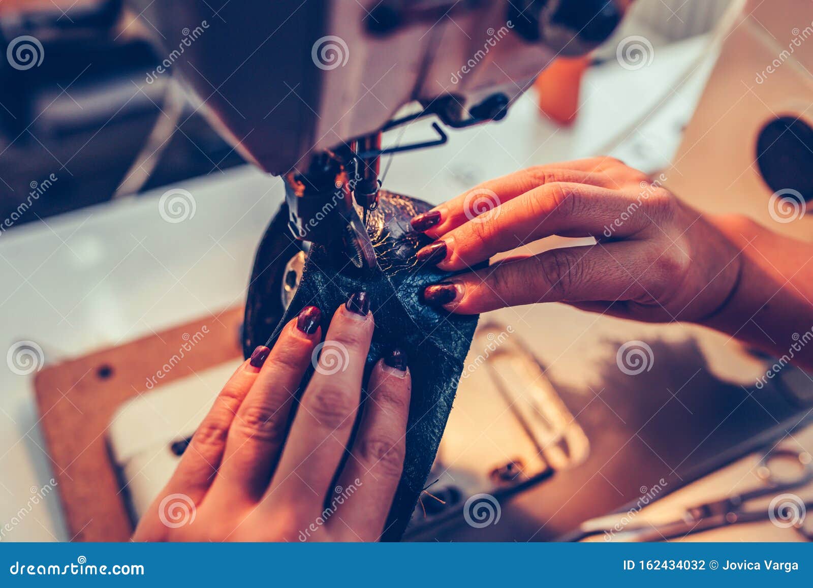 Close Up a Female Hands Stitching a Part of the Shoe at a