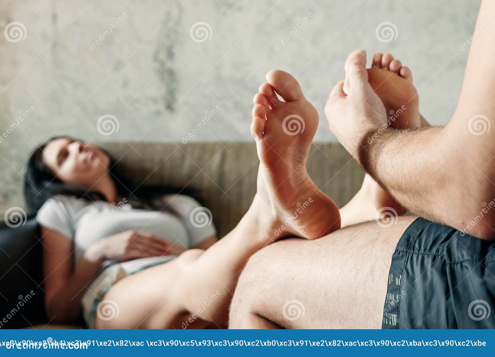Close-up of Female Legs Receiving a Foot Massage from Her Husband photo