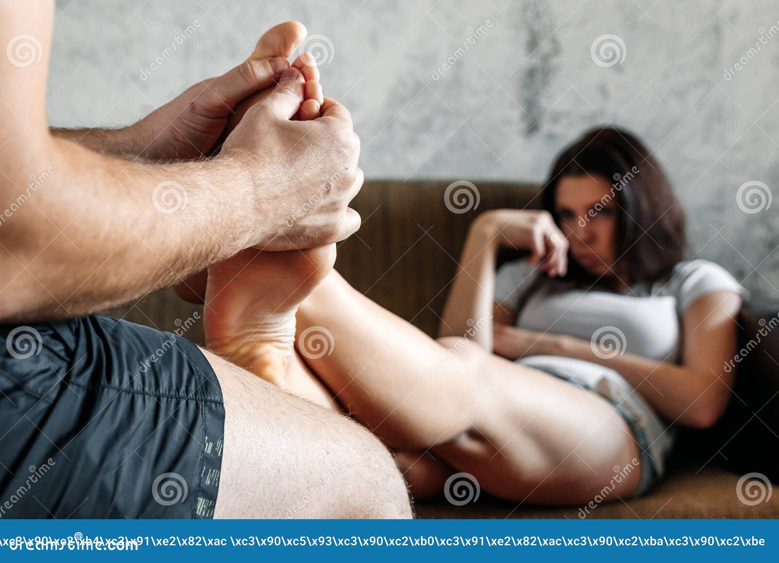 Close-up of Female Legs Receiving a Foot Massage from Her Husband