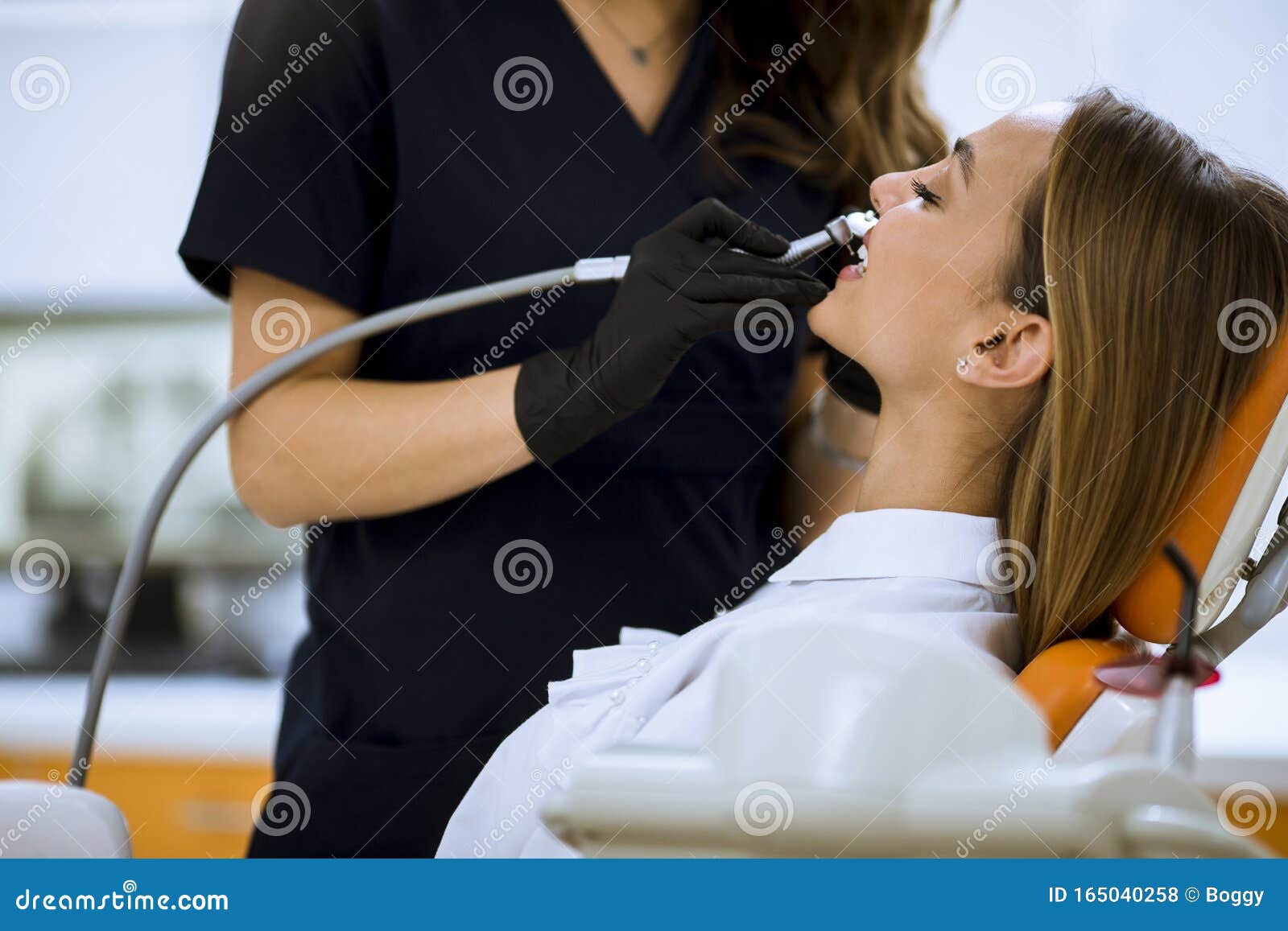 Close Up Of Female With Open Mouth During Oral Checkup At The Dentist