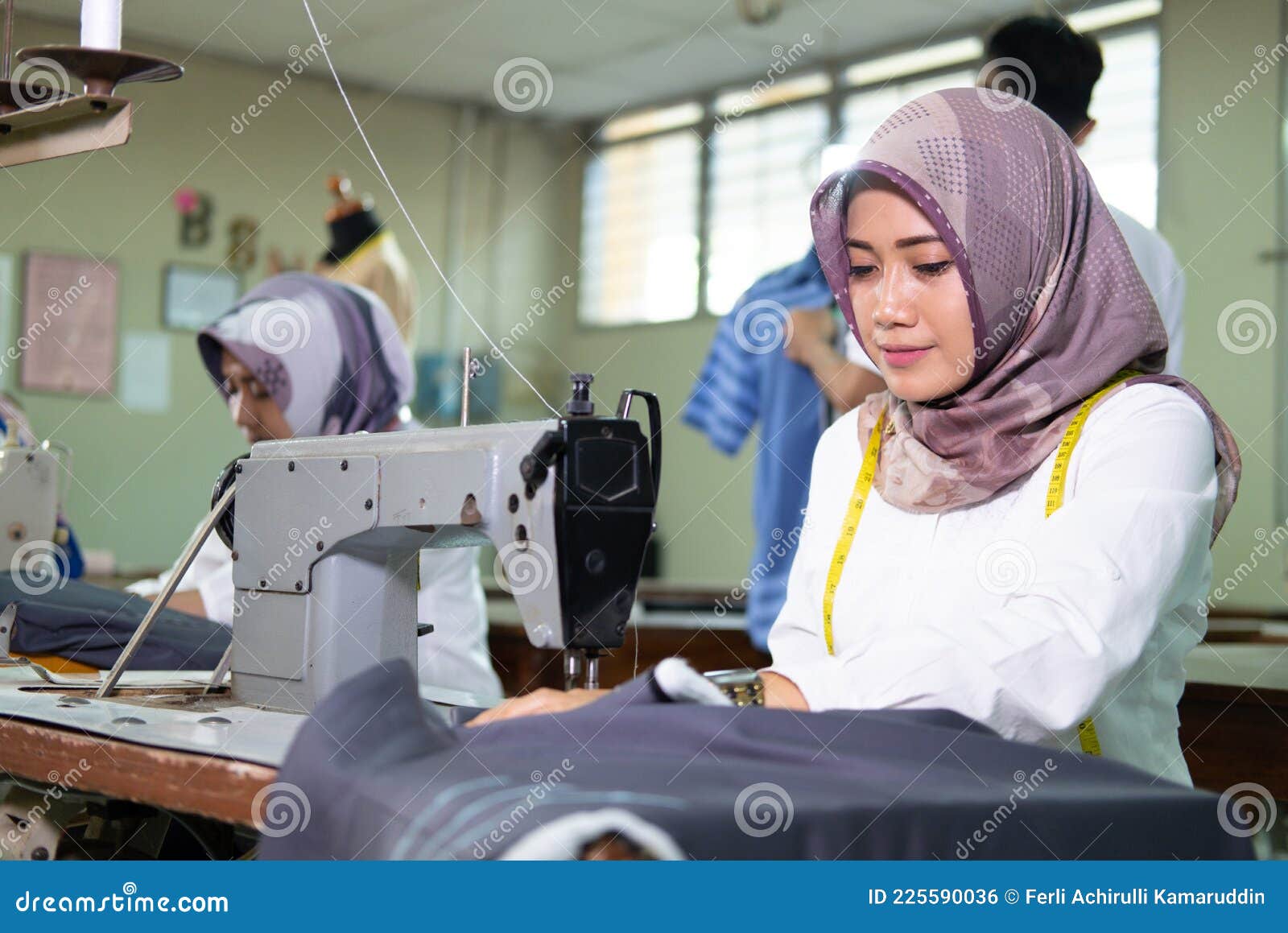 Close Up Female Tailor in Hijab Using a Sewing Machine while Workin ...