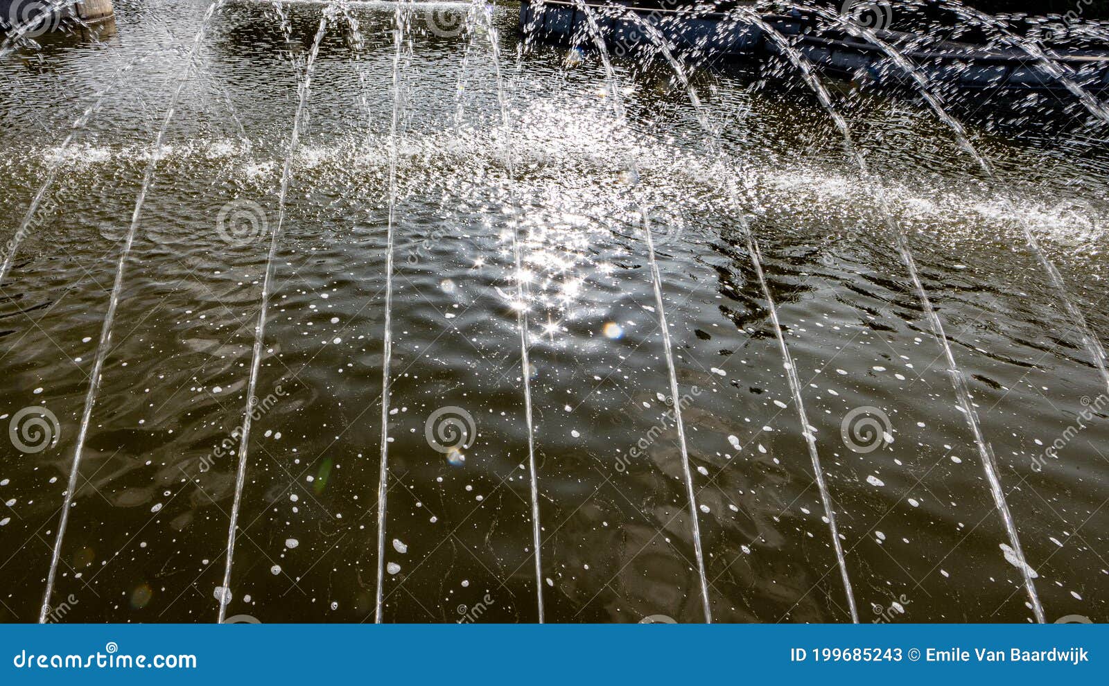 close-up of fine jets of water coming out of a fountain into a pond with clean water