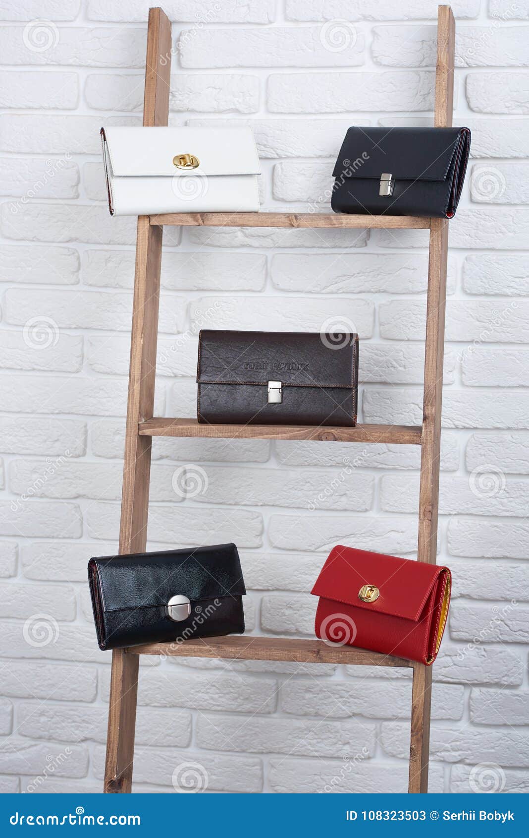 five women s leather bags on the white wall background