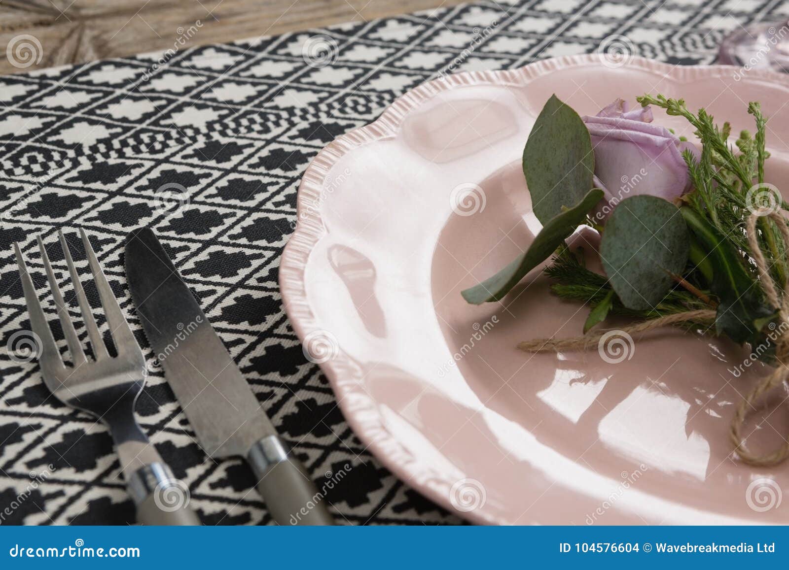 Fork and Butter Knife with Flower and Plate Arranged on Table Cloth ...