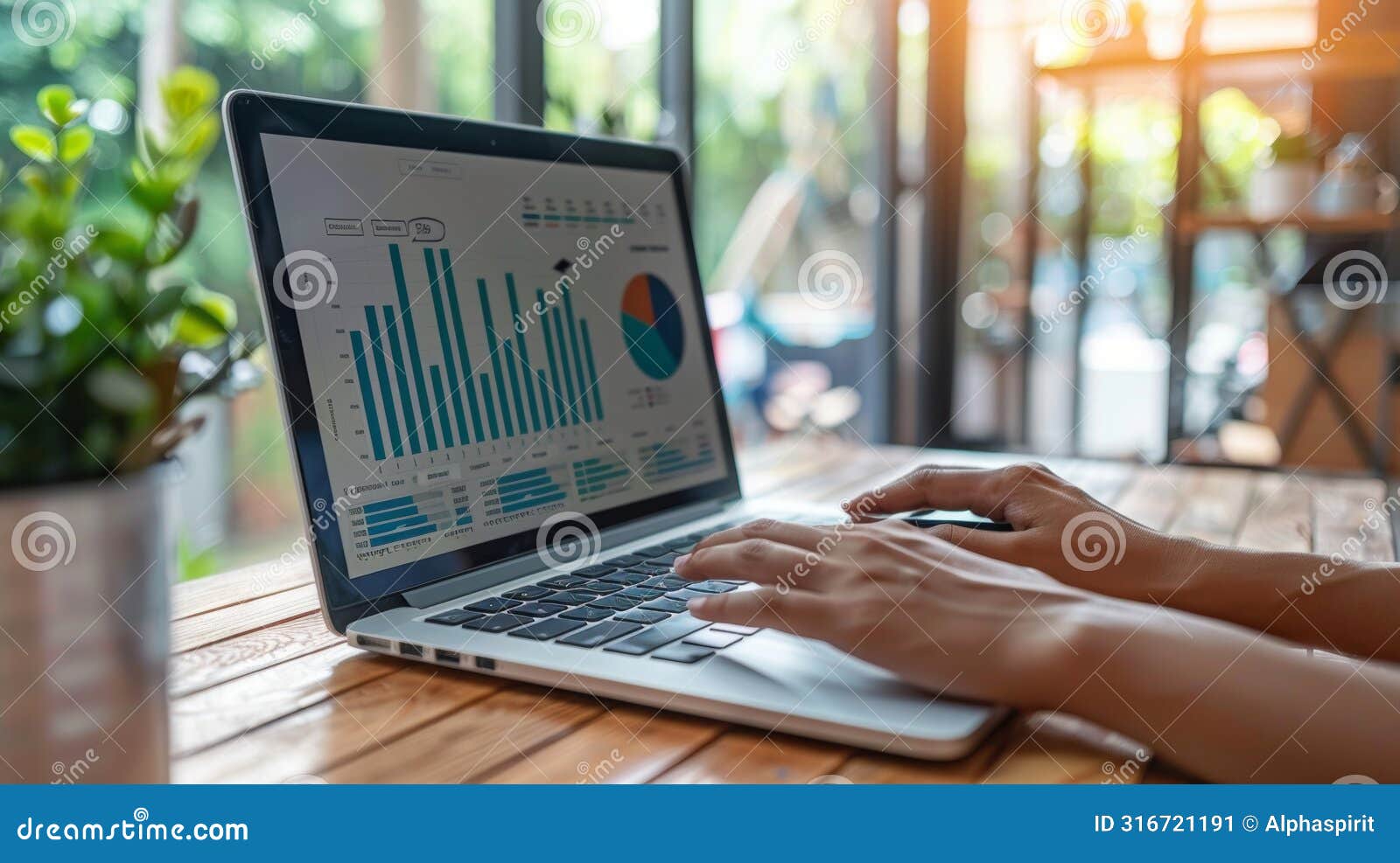 close-up of a freelancer's hands analyzing bar graphs and pie charts on a laptop screen
