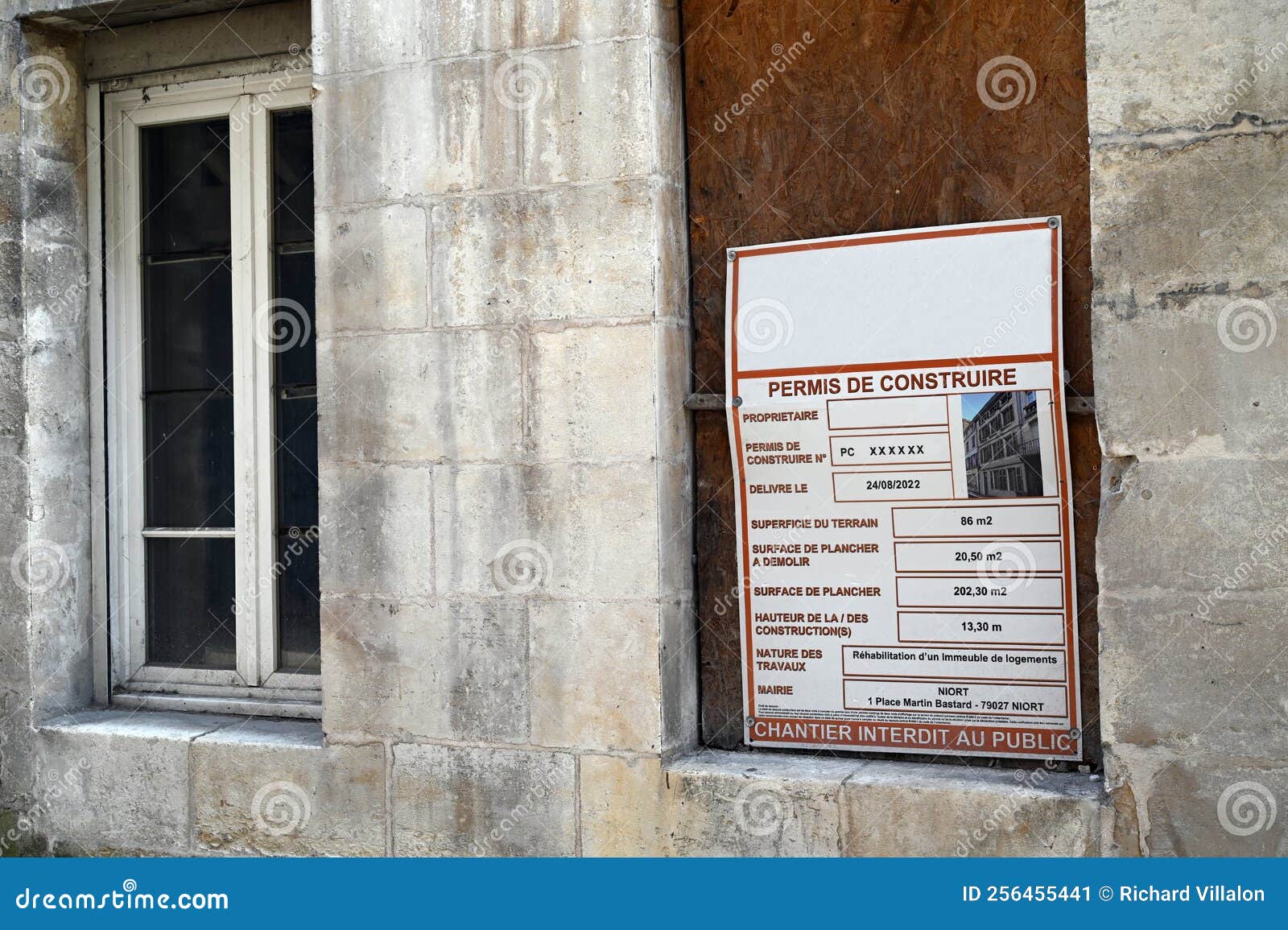 Building Permit Displayed on a Building Under Renovation Editorial