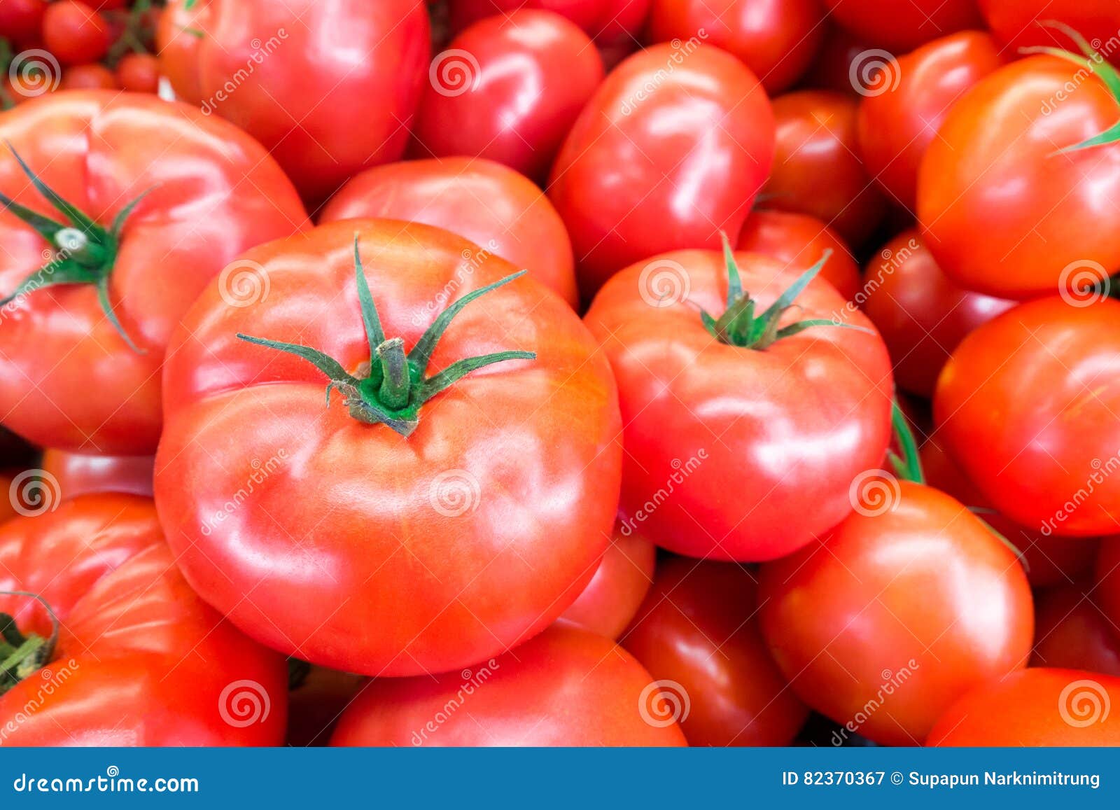 close up of fresh, juicy, ripe tomatoes pile. lycopene and antioxidant in fruit nutrition good for health and skin. flat lay.