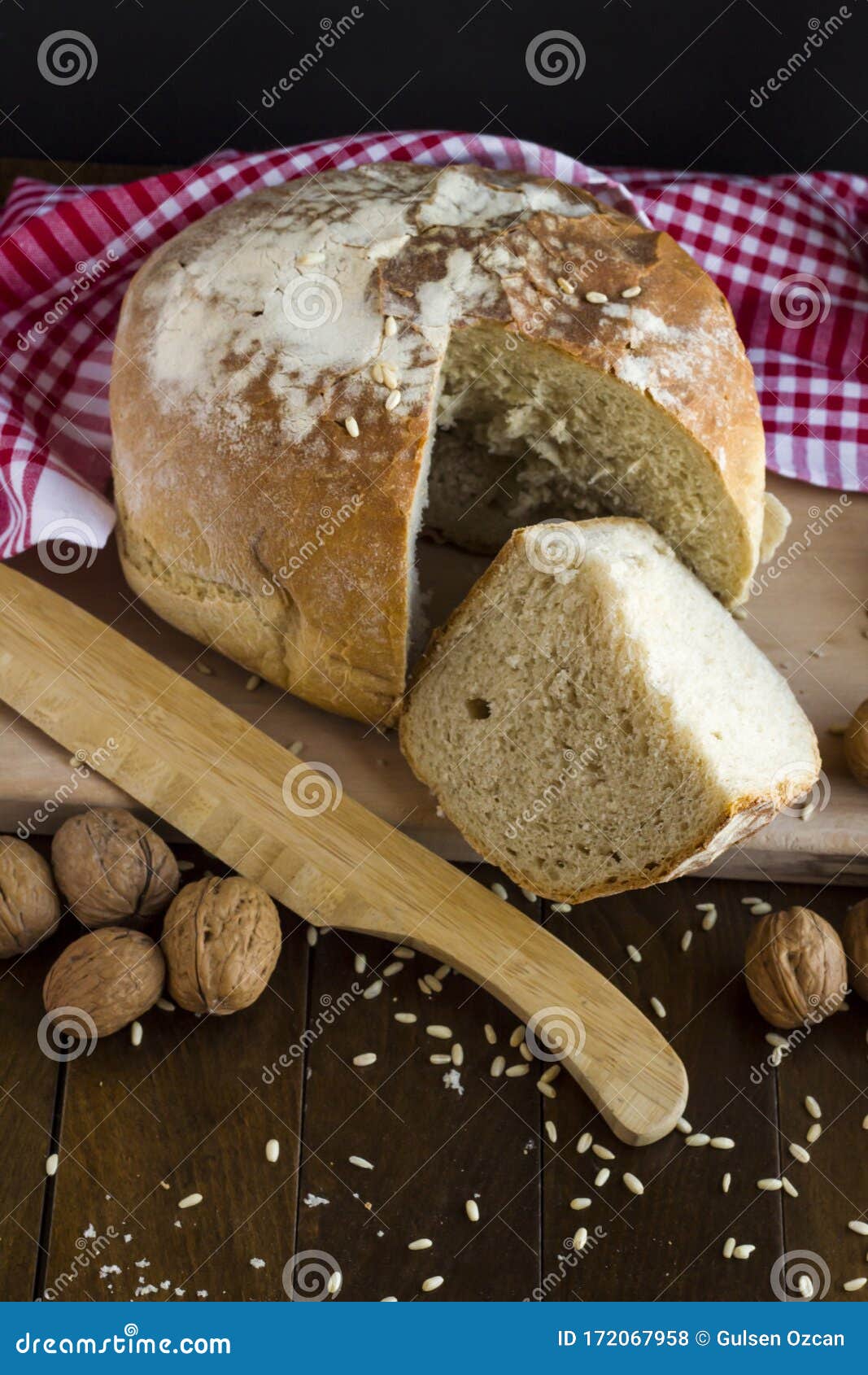 fresh,sourdough german round bread on wooden table,sliced one piece
