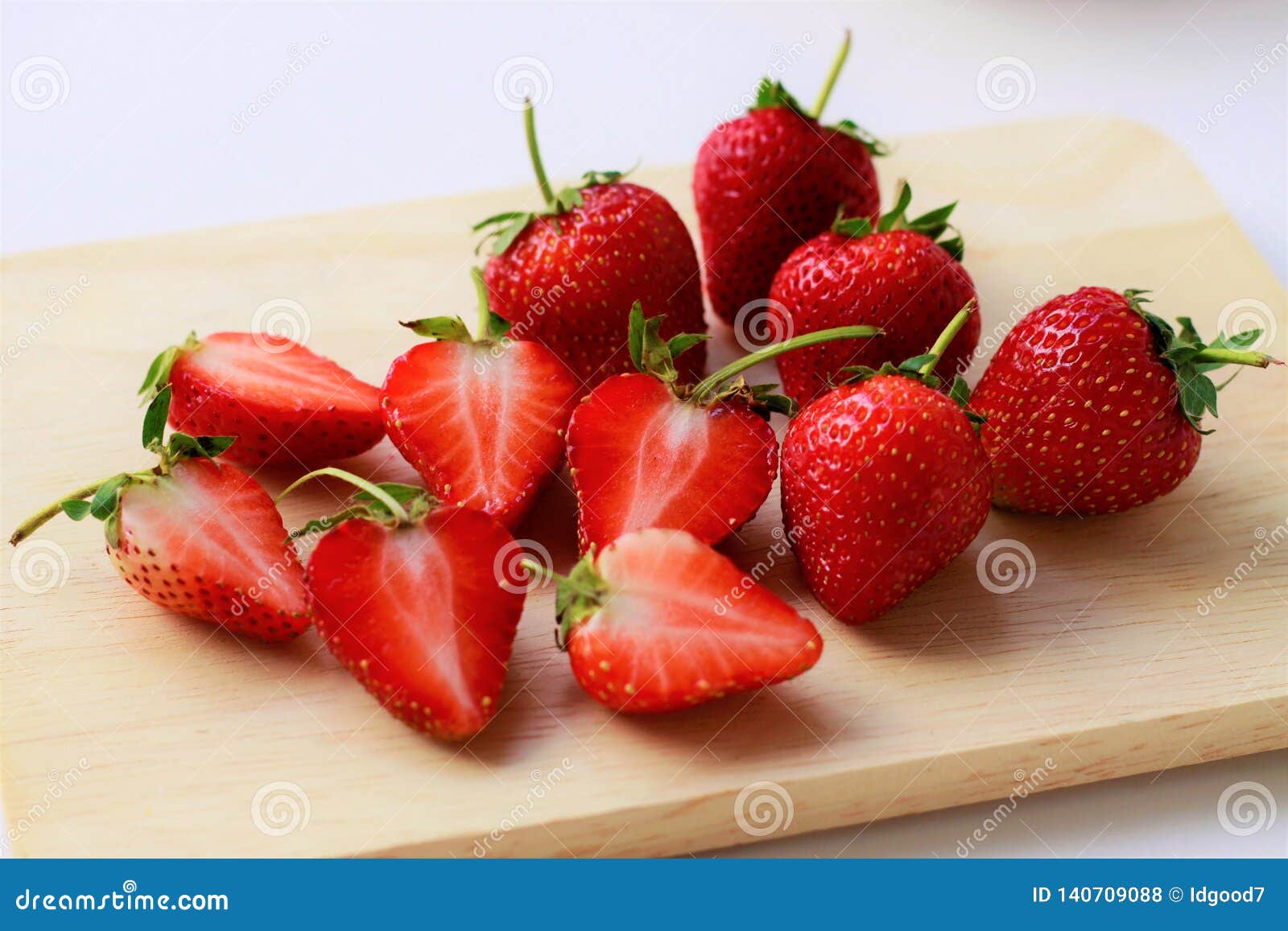 Close Up Fresh Strawberries Cut in Half and Whole Strawberries on