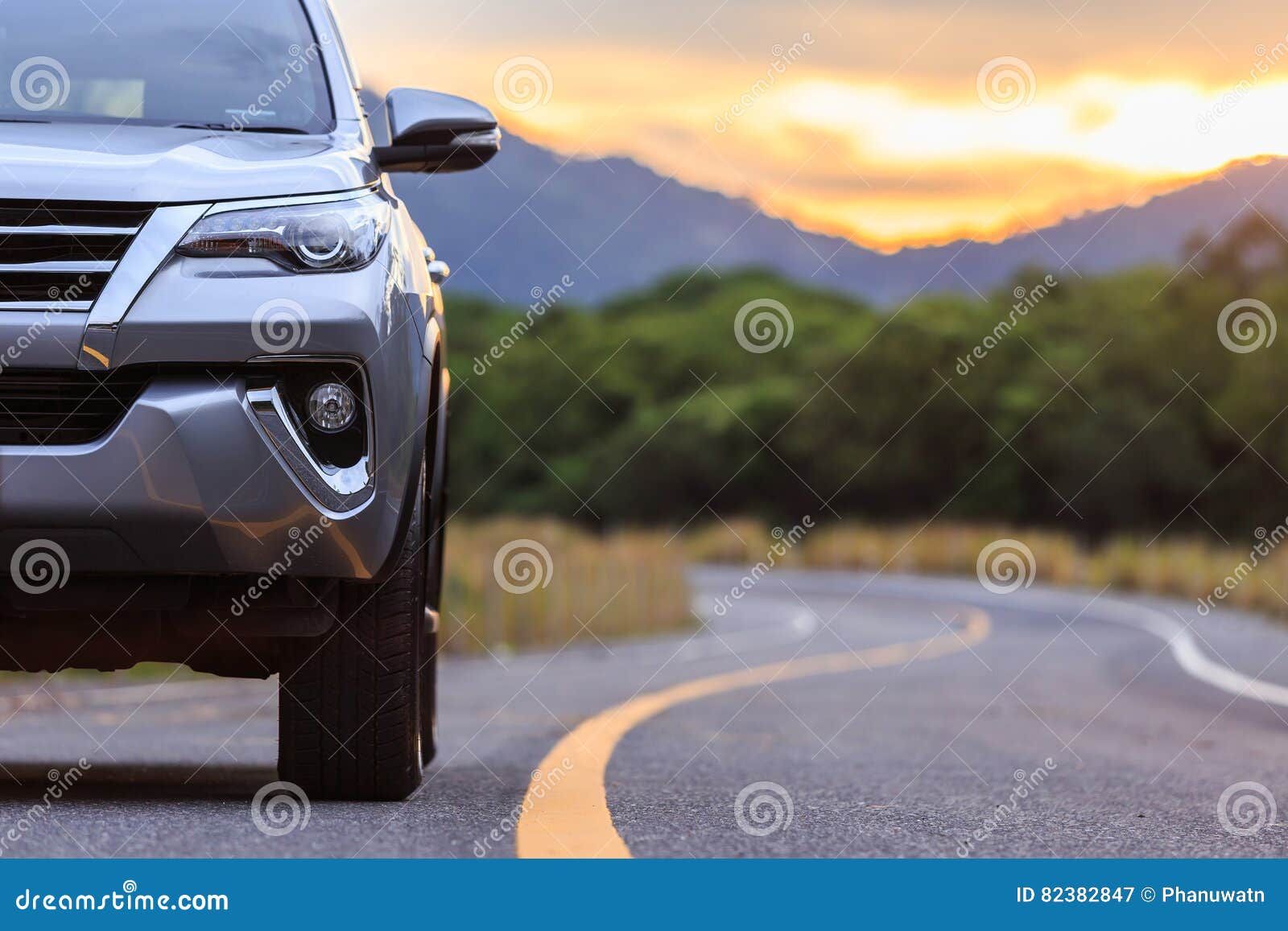 close up front of new silver suv car parking on the asphalt road