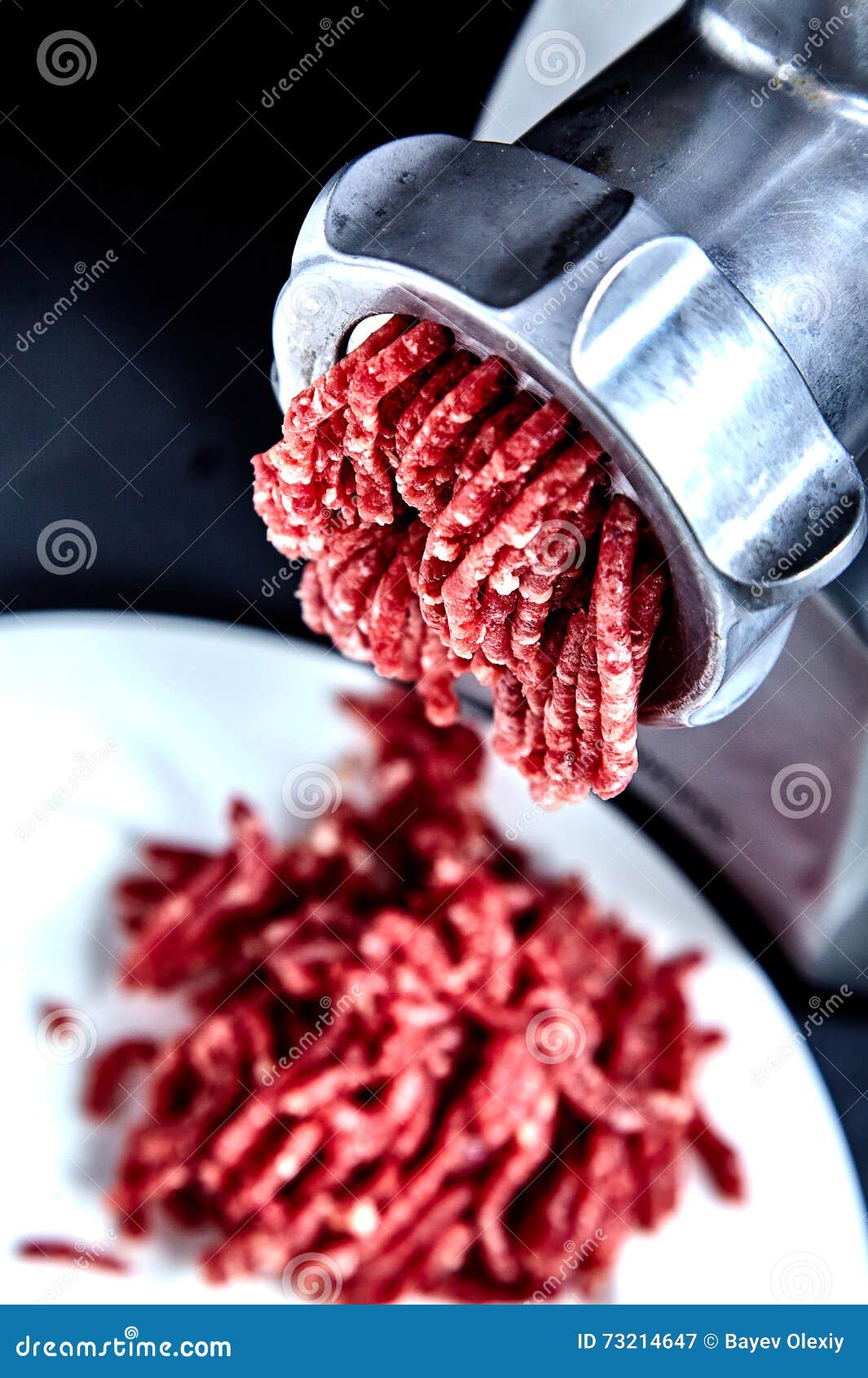 close up front part of mincing-machine with forcemeat in