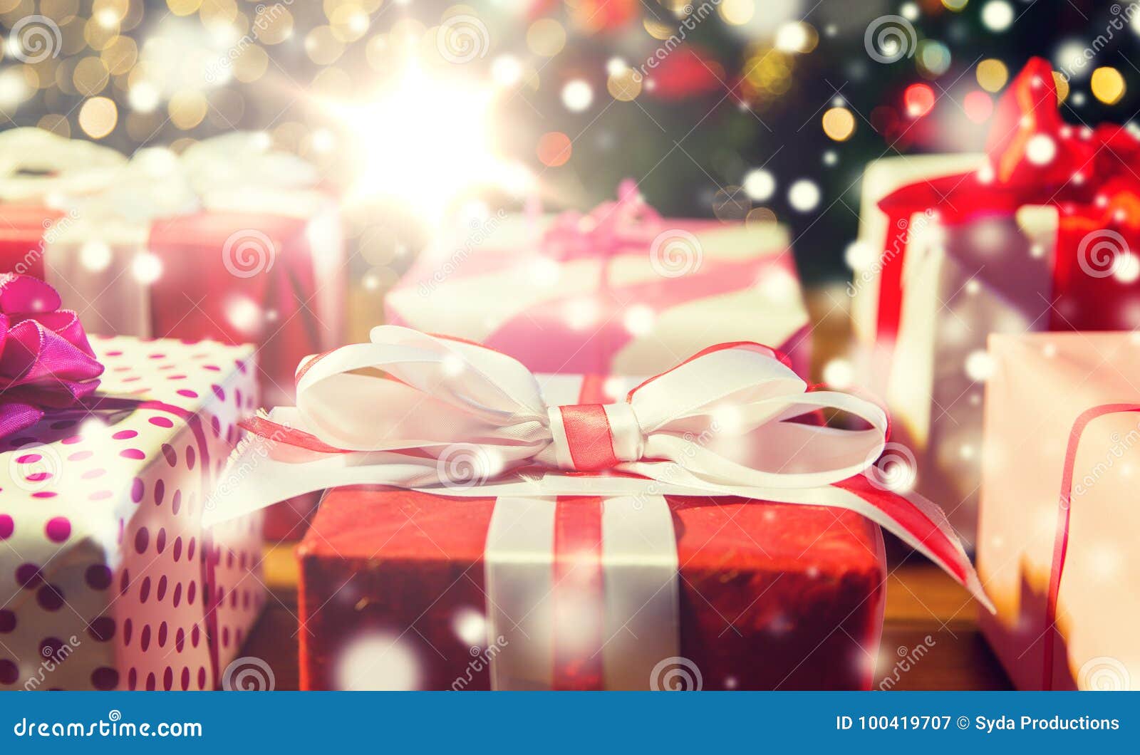 Close Up of Gift Boxes Over Christmas Tree Lights Stock Image - Image ...