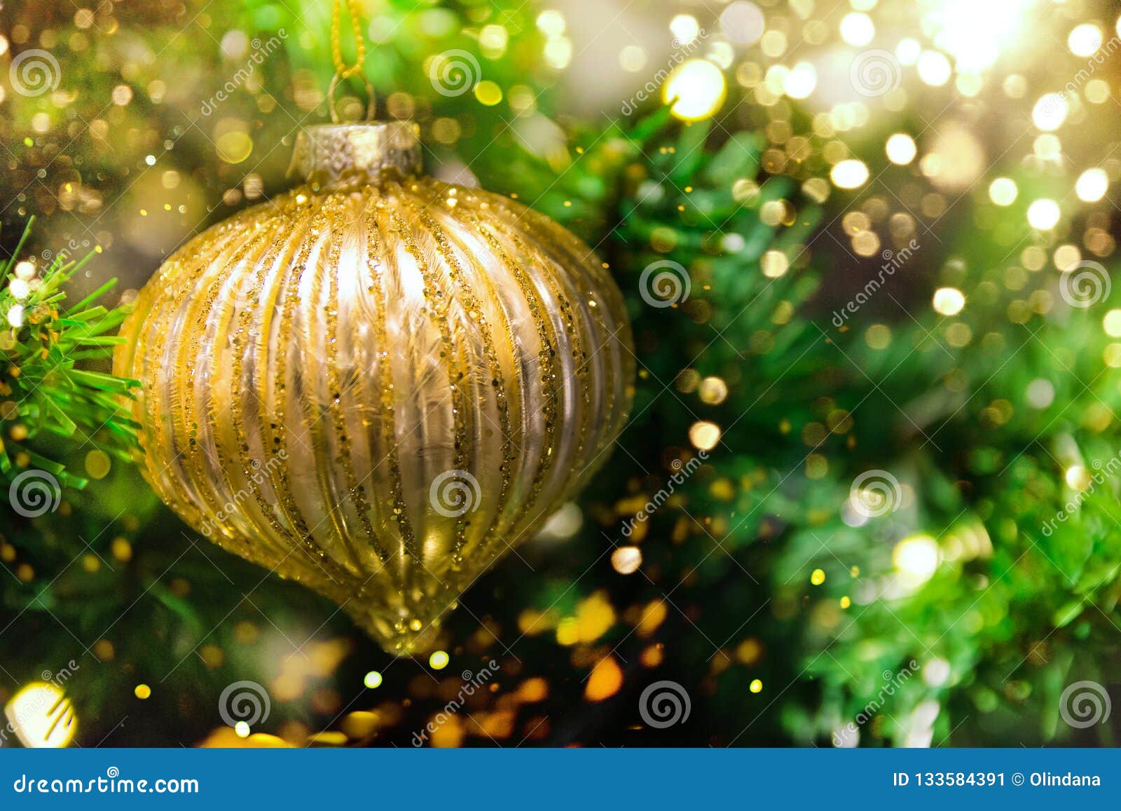 Close Up of Golden Ball Ornament Hanging on Decorated Christmas Tree ...