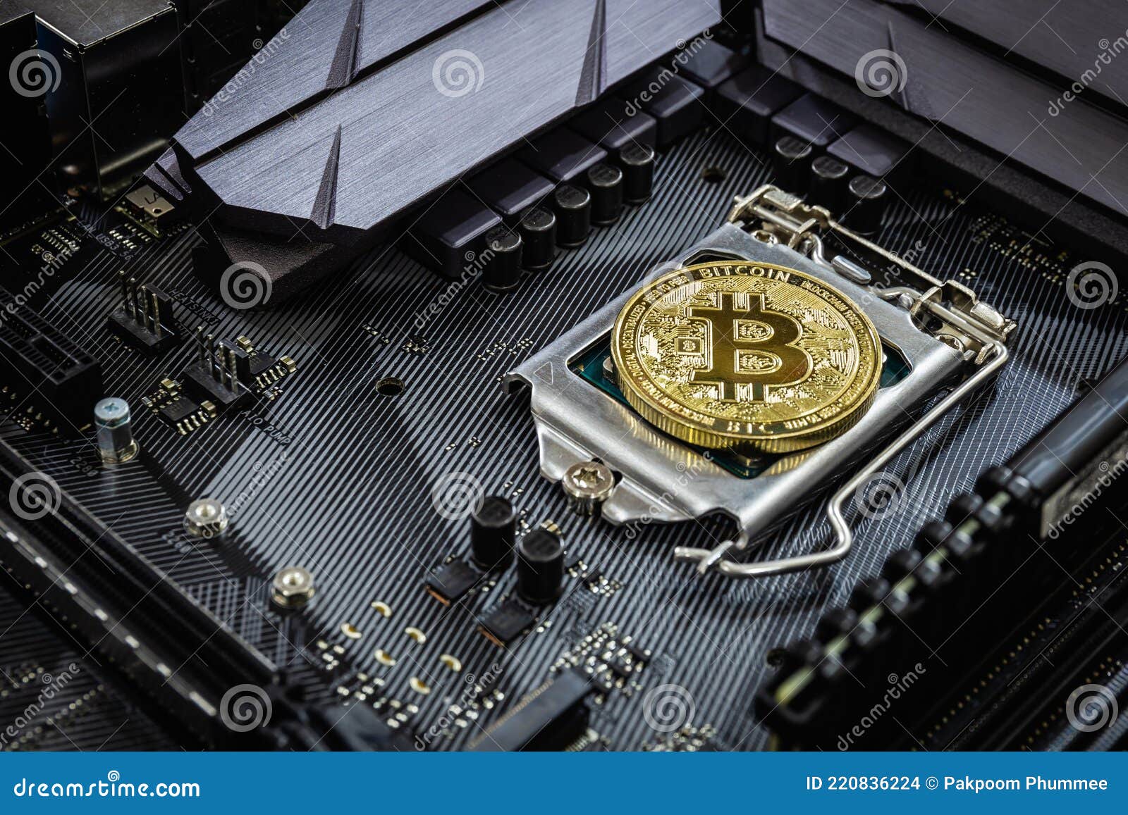 close up of golden bitcoin on cpu socket in computer. crypto currency concept and online trading
