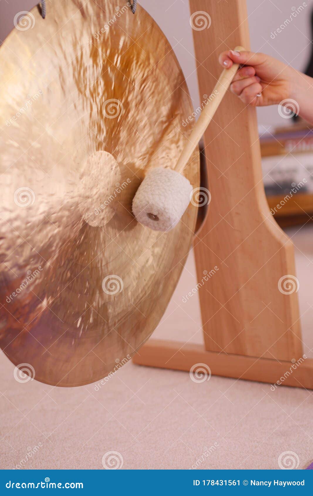 Close Up of a Gong with a Handheld Stick during a Sound Healing Therapy