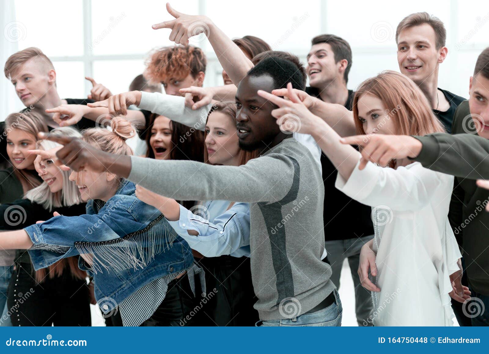 Close Up. a Group of Young People Pointing at One Point Stock Photo ...