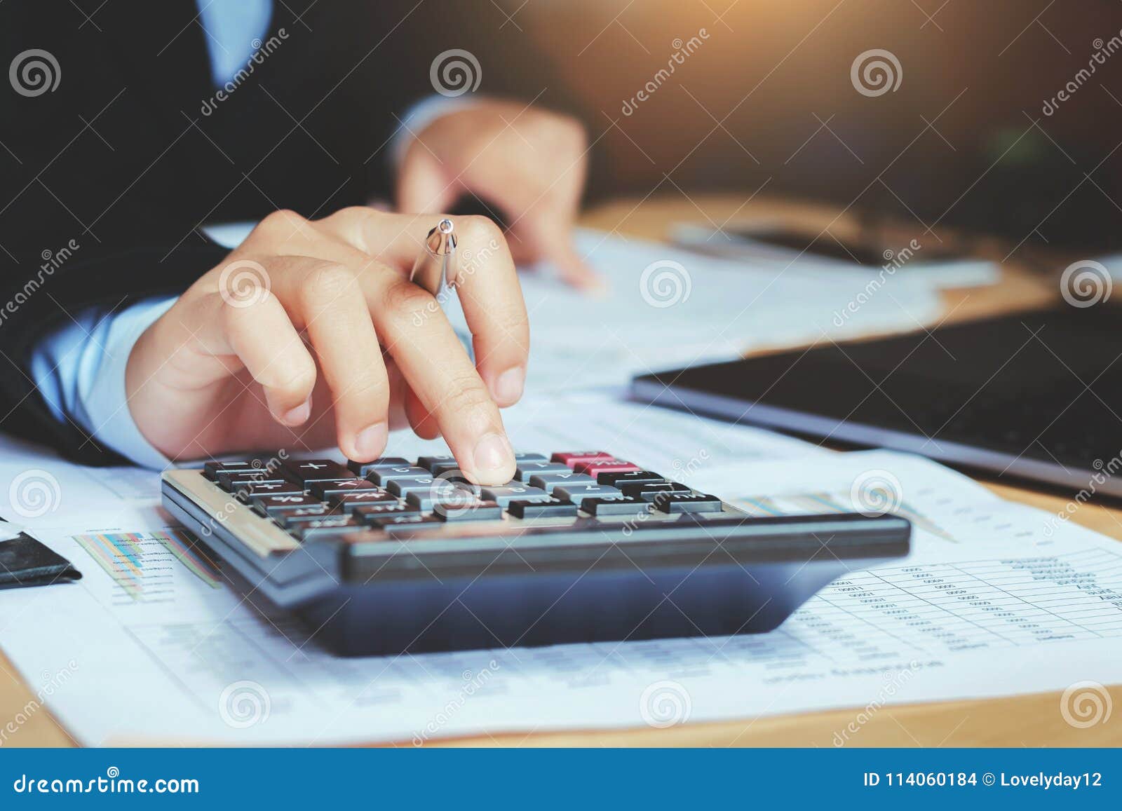 close up hand accountant using calculator with laptop. concept s