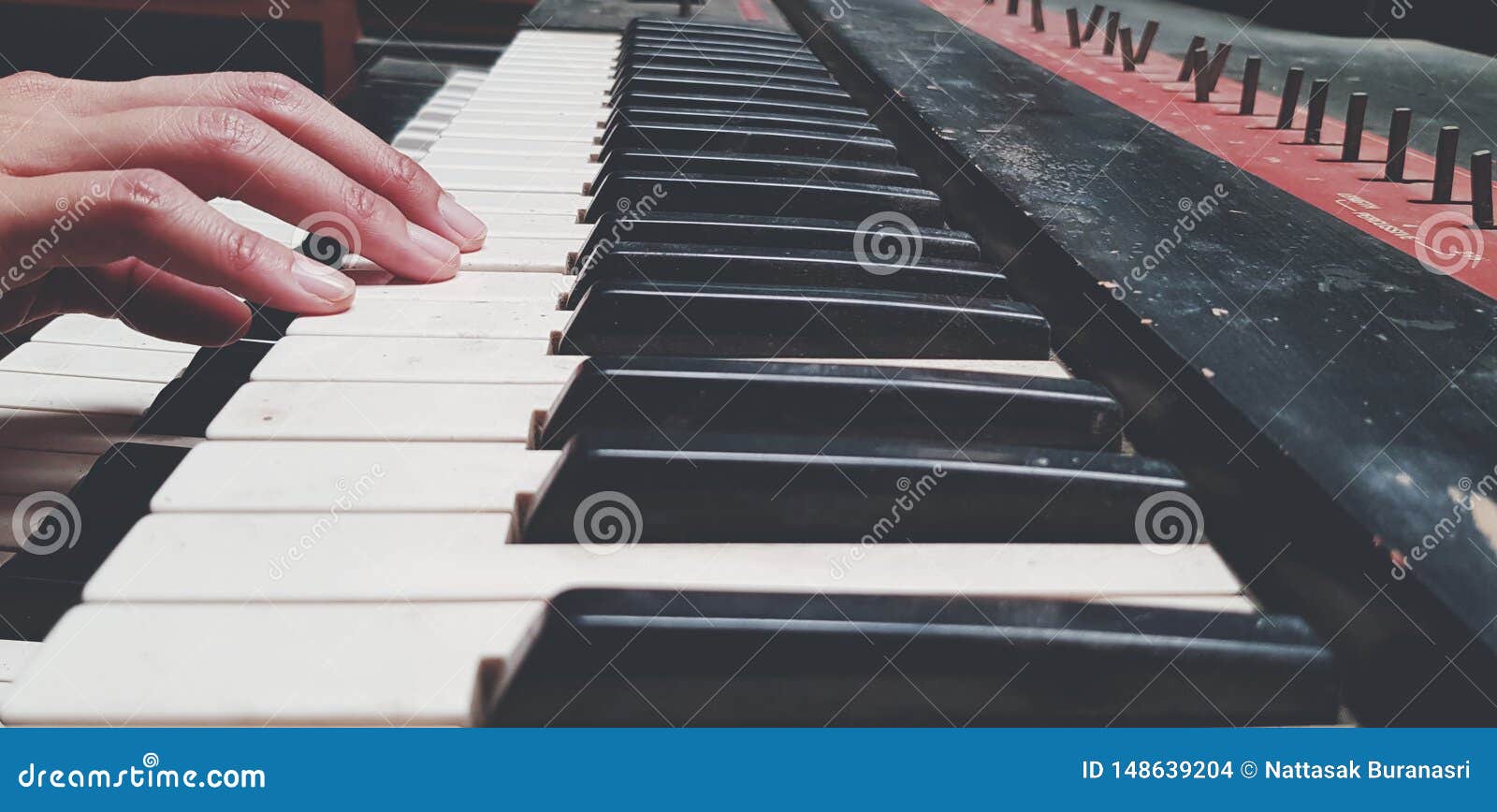 close up hand of people playing piano or press elect tone keyboard in vintage color style