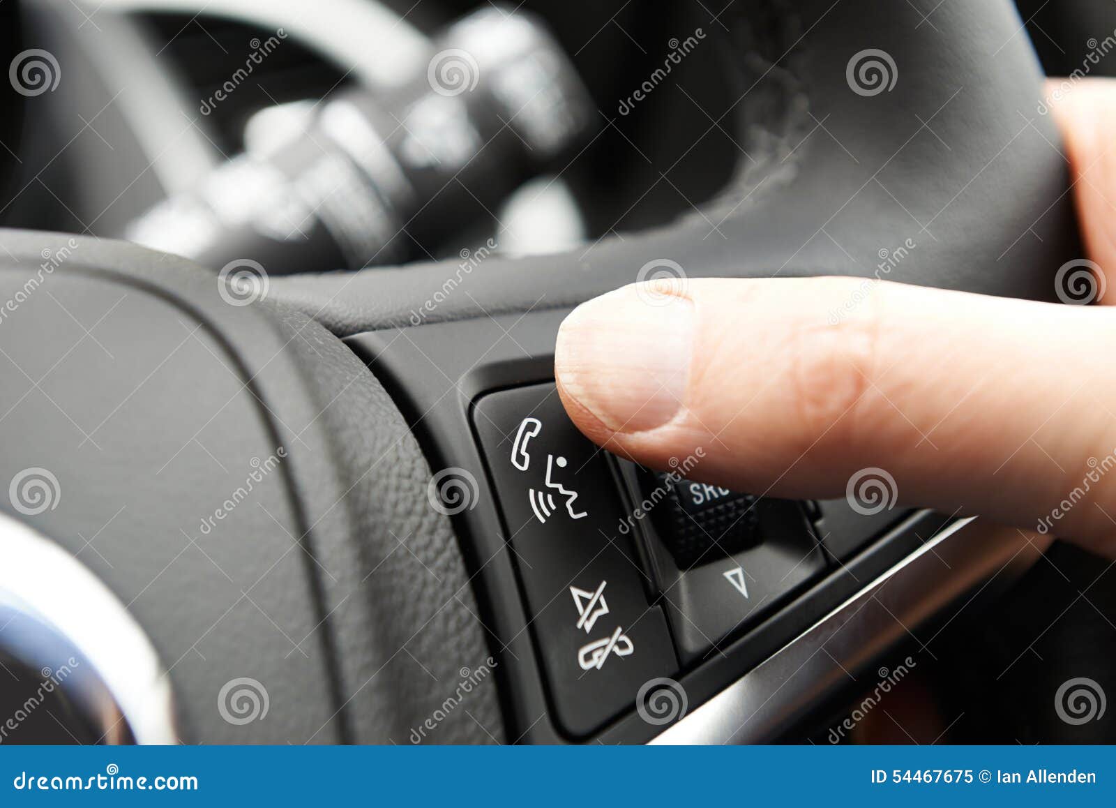 Close Up of Hand Pressing Car Bluetooth Control on Steering Whee Stock