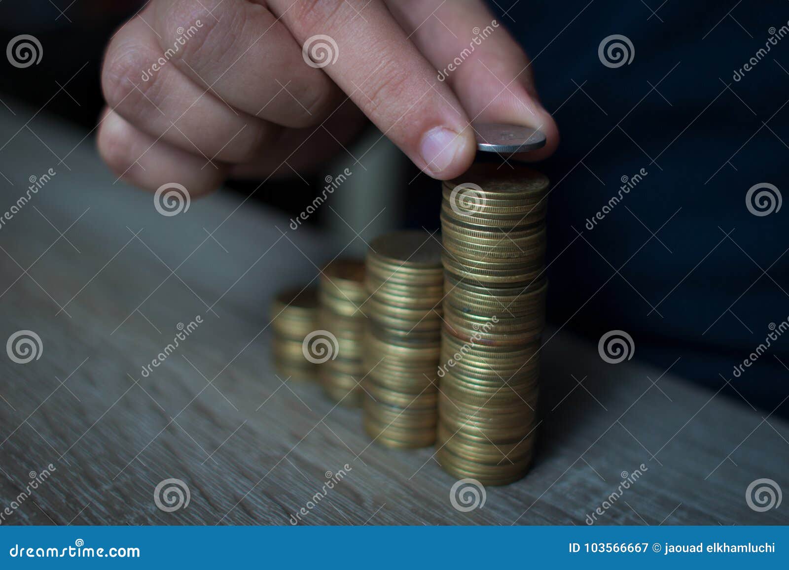 close-up of hand put coins to stack of coins,concept saving money
