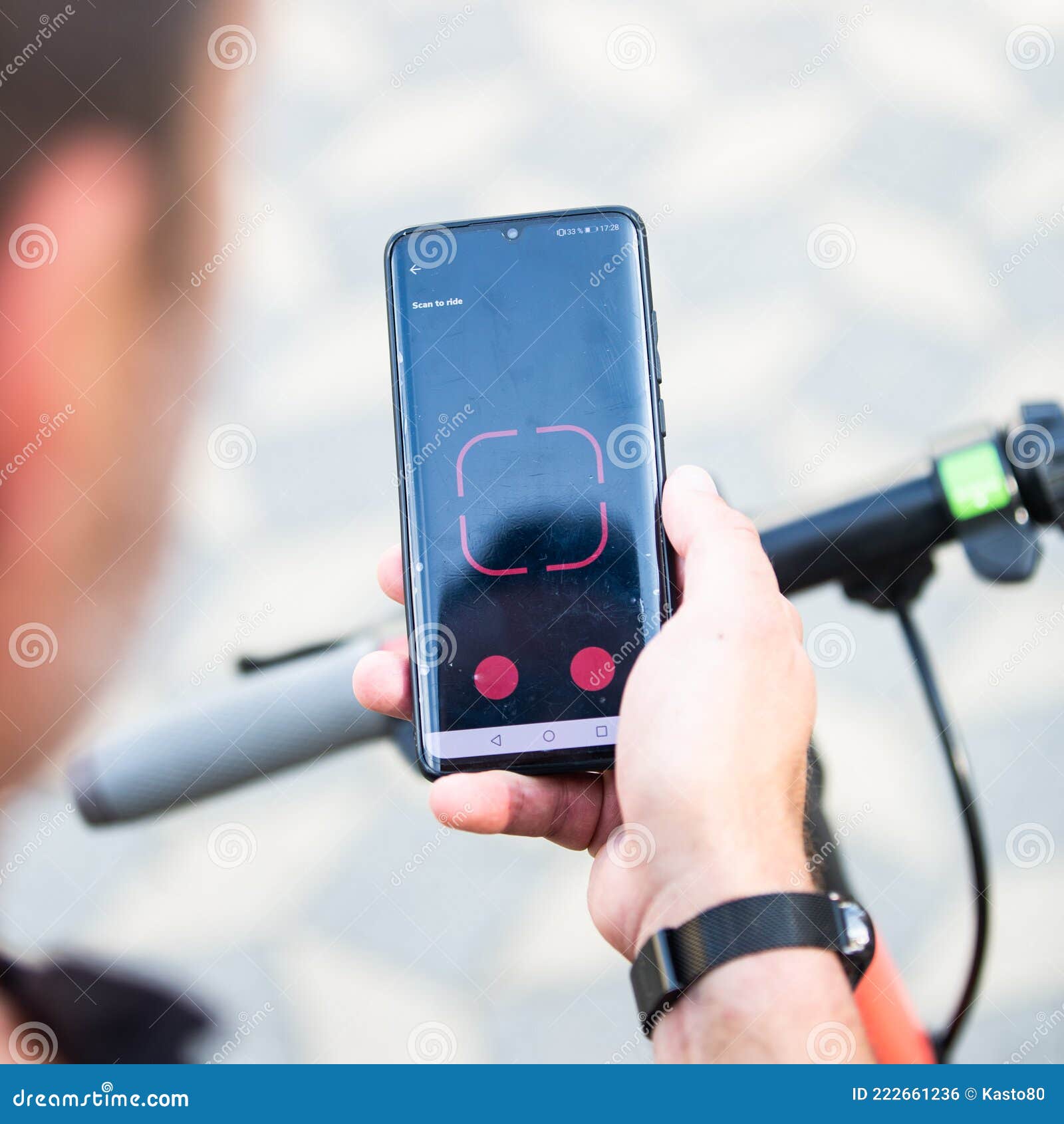 close up of hand and smartphone, unlocking dockless electric scooter for rent with debranded generic phone app.