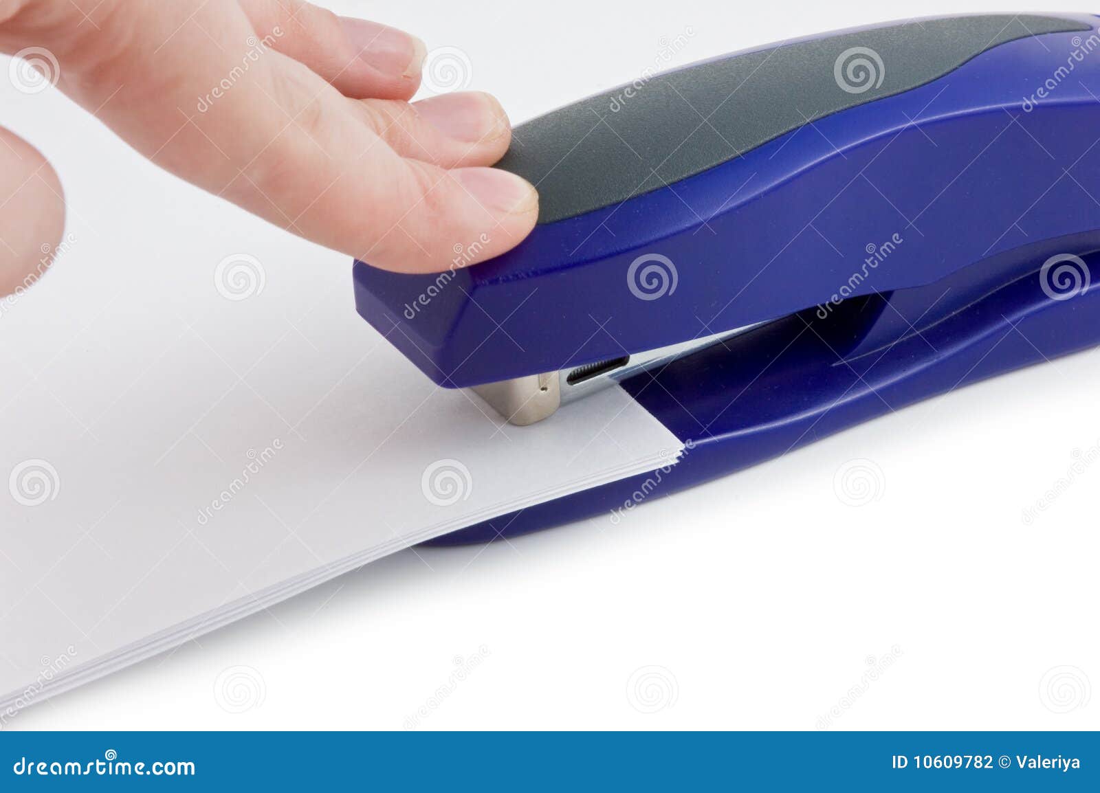 Close up of hand stapling bills. Close up of hand stapling bills isolated on white background