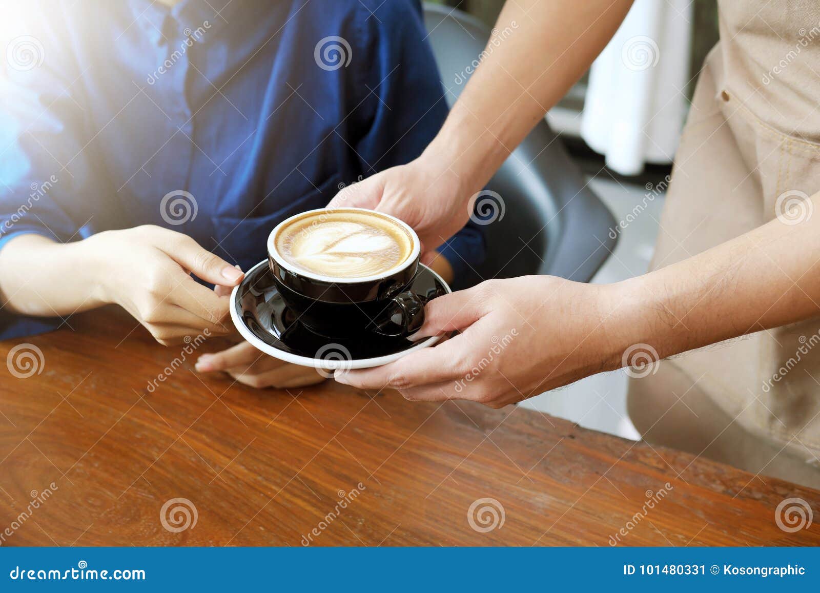 Closeup Hand of a Waitress Serving a Cup of Coffee To Customer. Stock