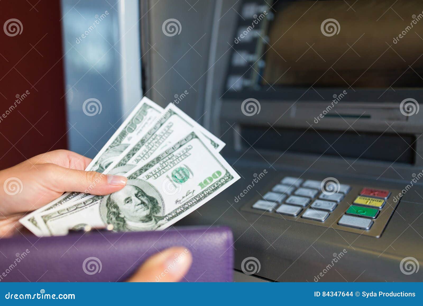 close up of hand withdrawing money at atm machine