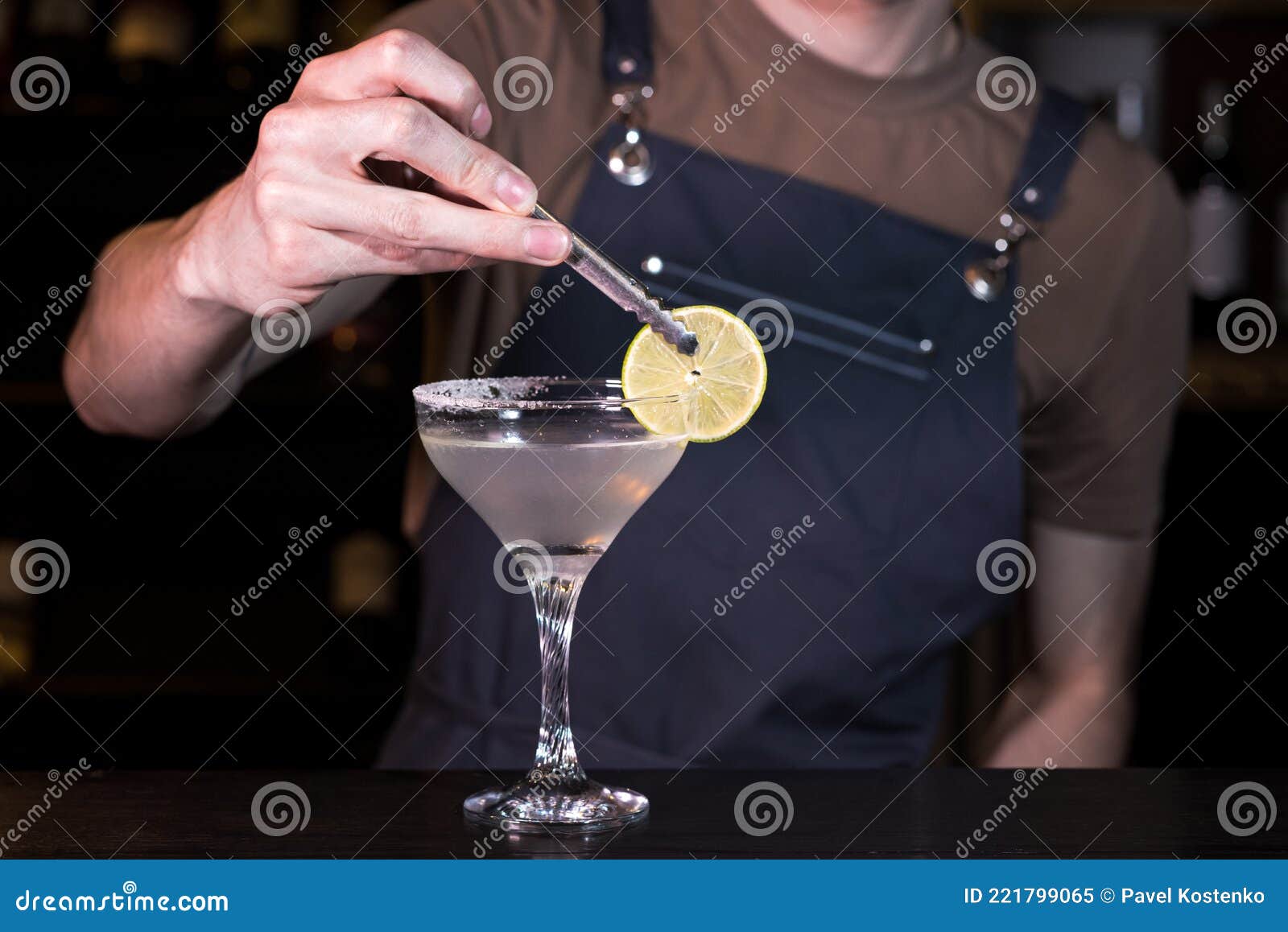 Close Up Hands of the Bartender Who Make a Margarita Cocktail. Stock