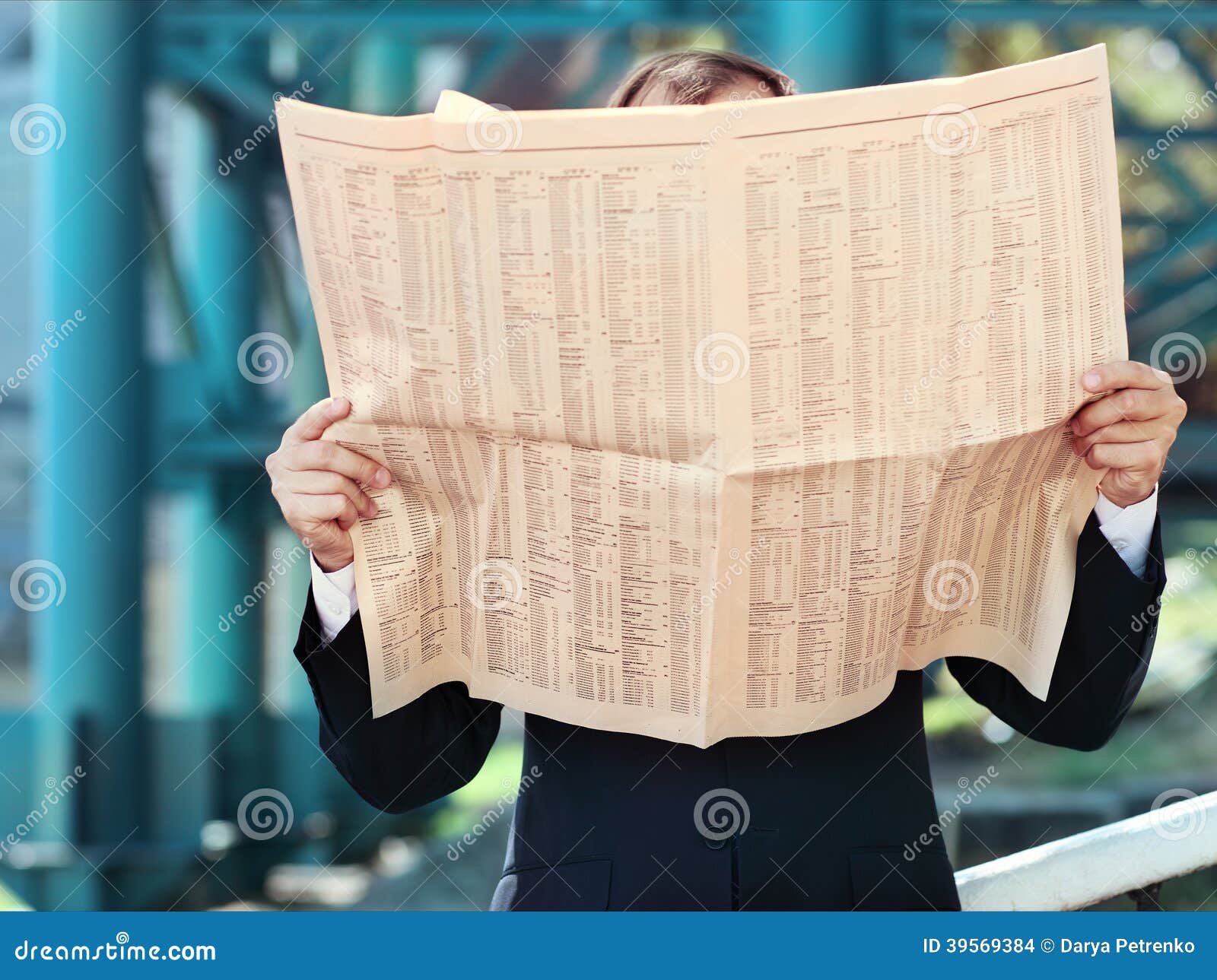 Close Up of the Hands of the Businessman with a Newspaper Stock Photo