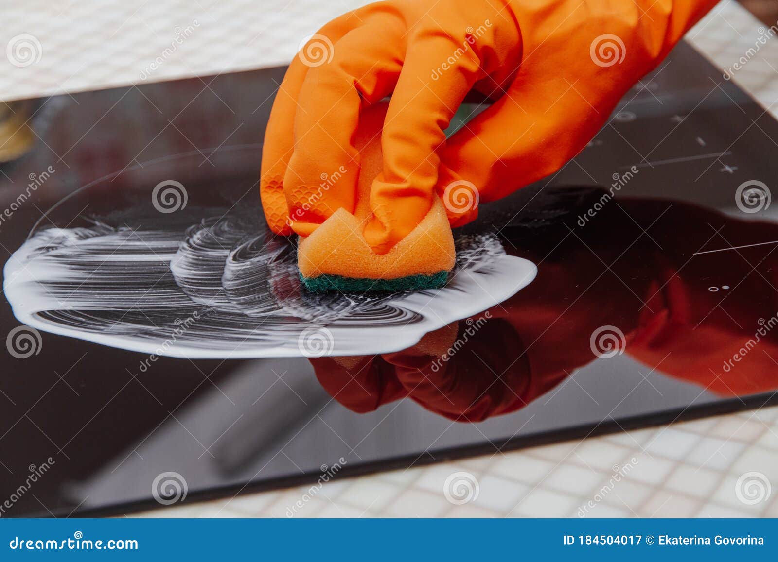 Close Up Hands Cleaning Kitchen Glass Ceramic Electric Surface with a