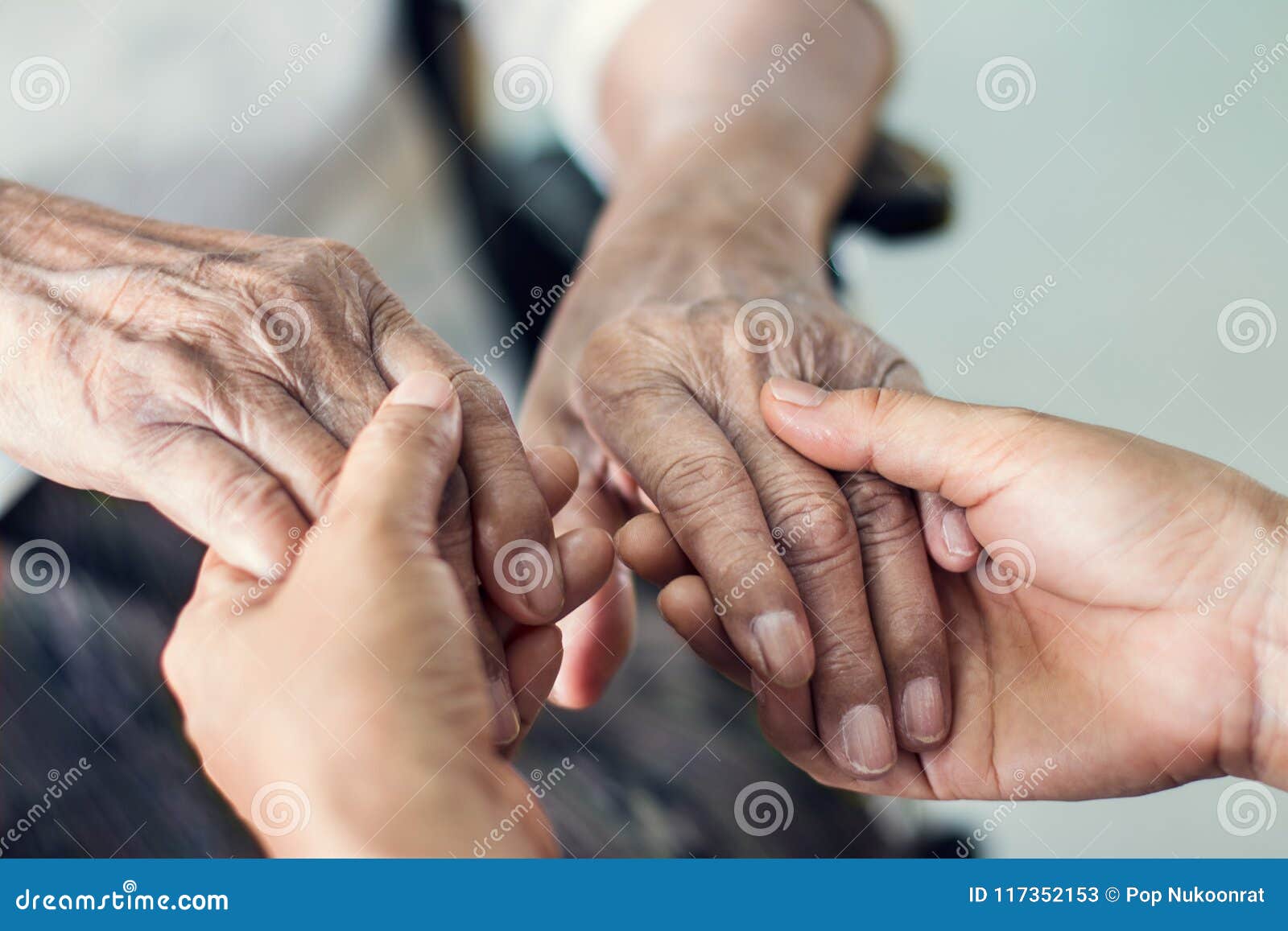 close up hands of helping hands for elderly home care.