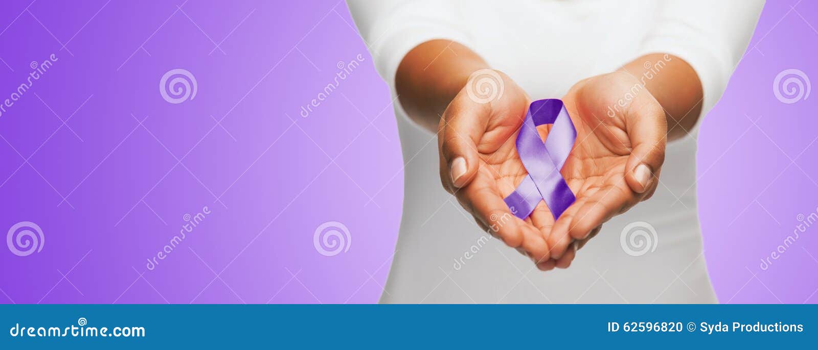 close up of hands holding purple awareness ribbon