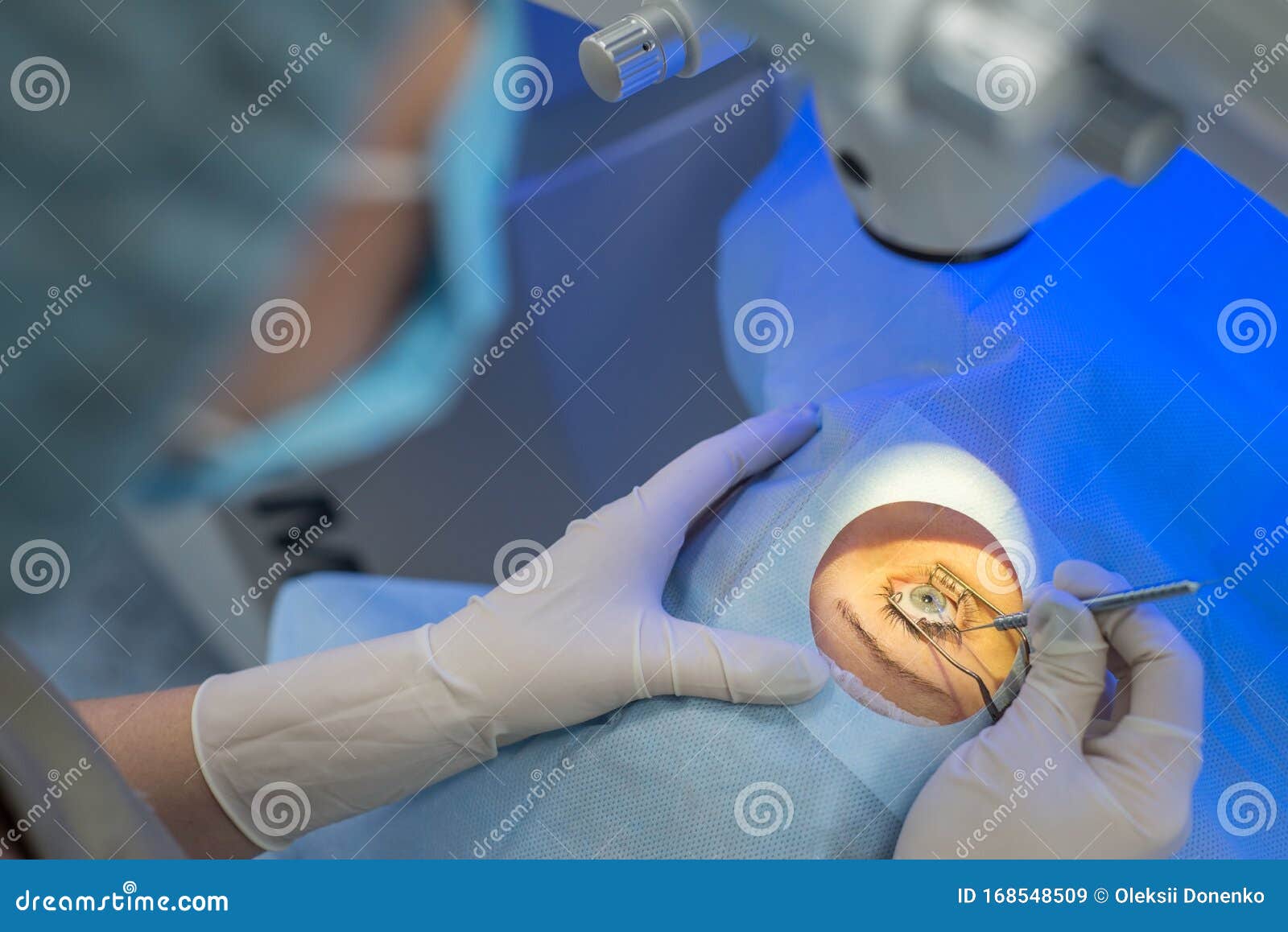 A Closeup of the Hands of an Ophthalmologist Surgeon Looking through a