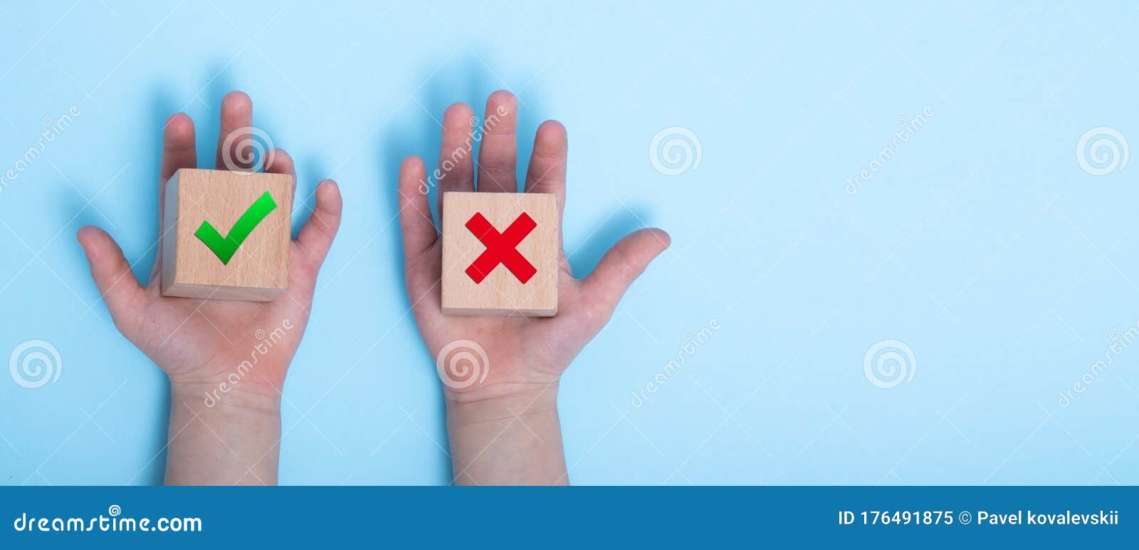 close-up of a hands placing two wooden blocks on a blue background. true and false s accept rejected for evaluation, yes or