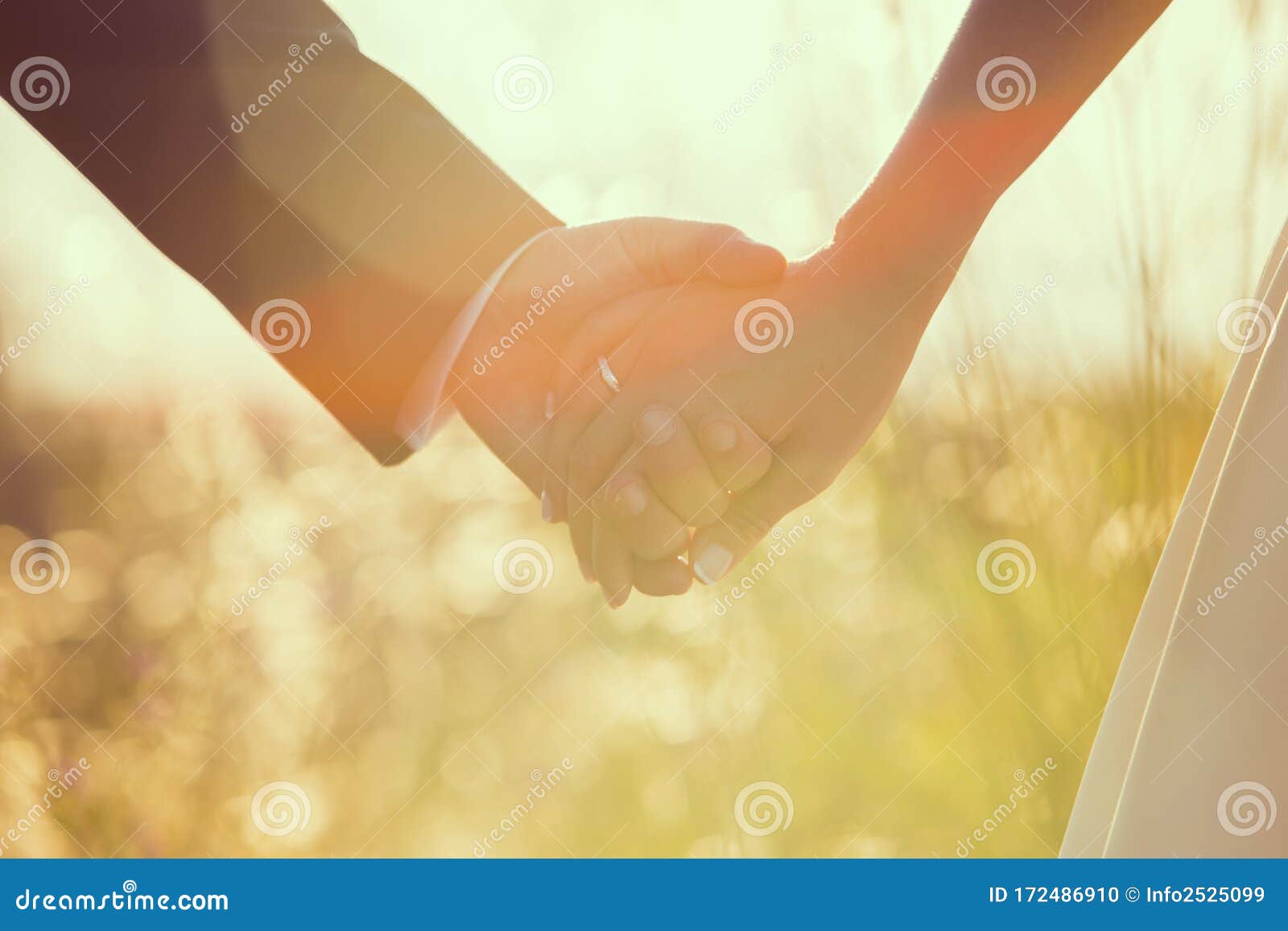 close up of hands in  of heart wedding just married