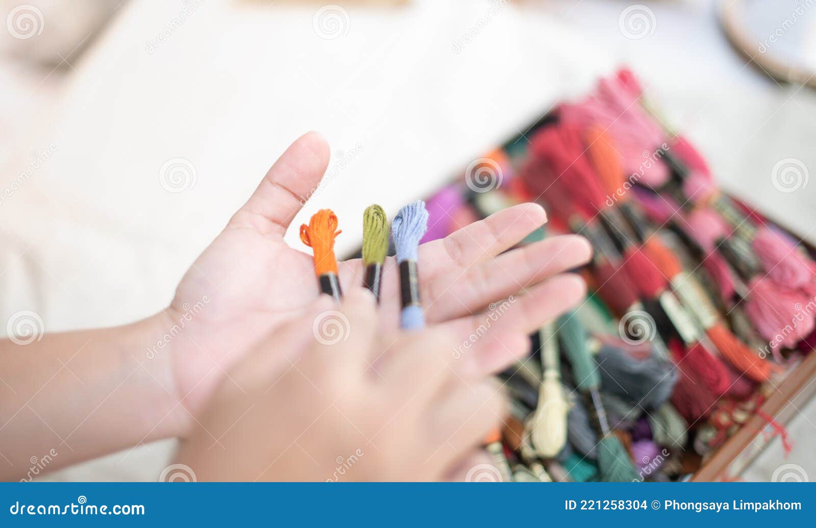 Female hands of designer at work with fabric close-up. Tailor