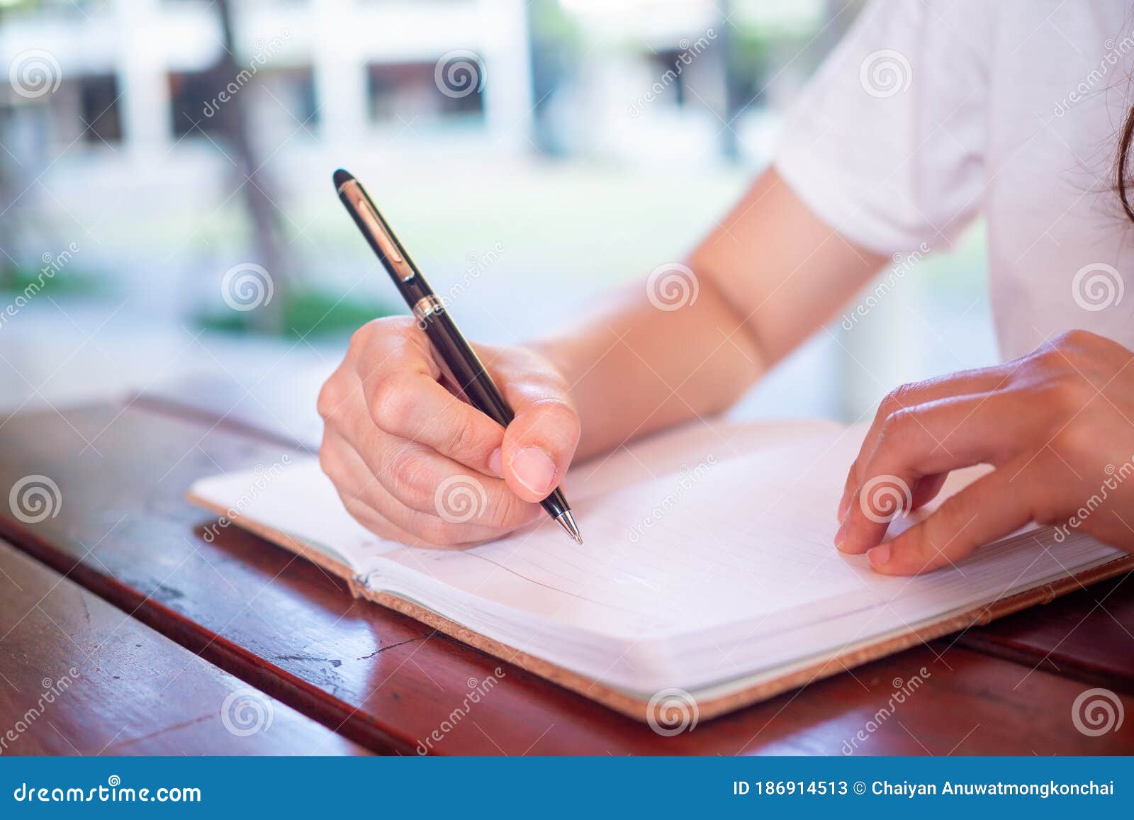 Close Up of the Hands of a Woman Holding a Pen To Write on a