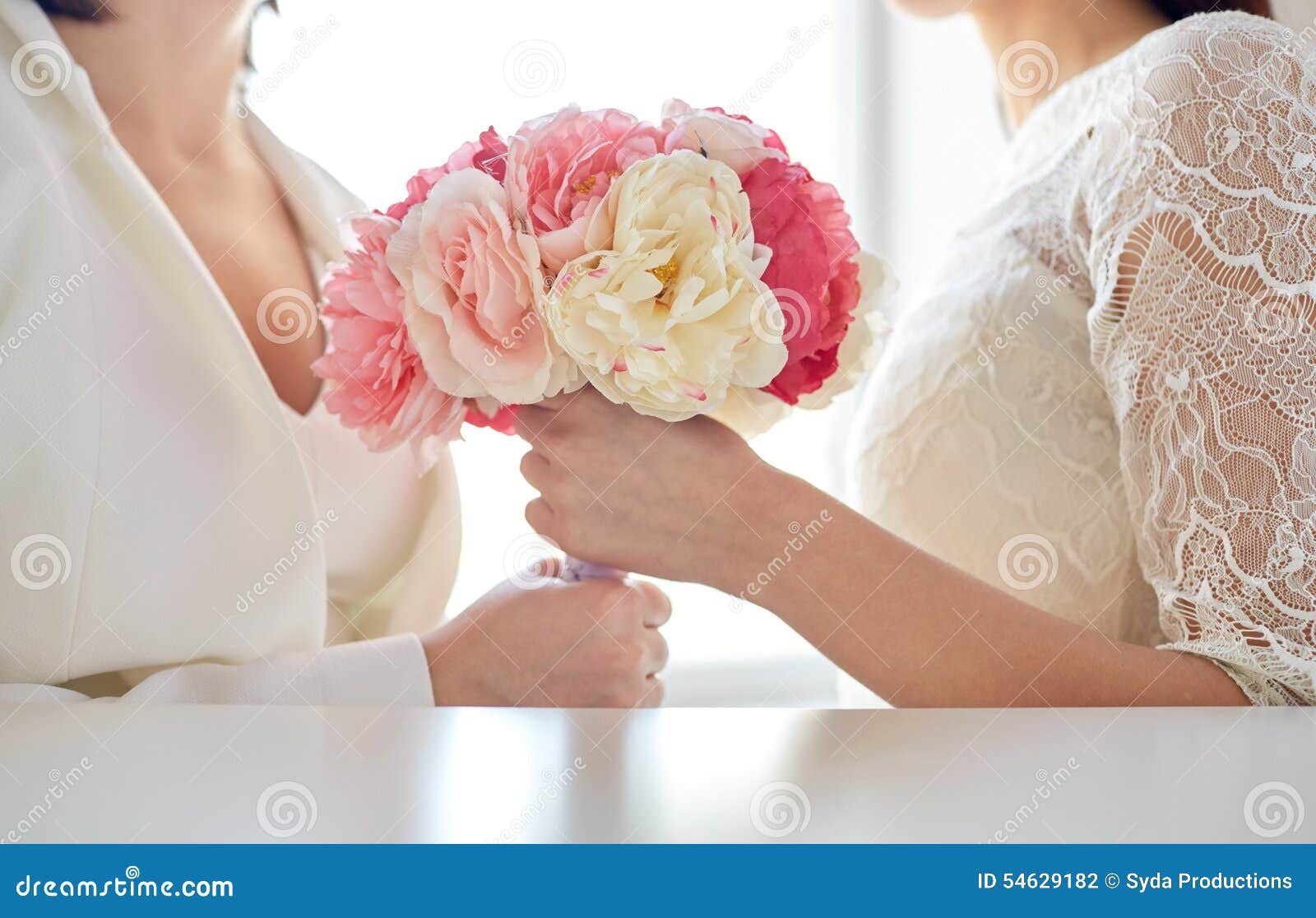 Close Up of Happy Lesbian Couple with Flowers Stock Photo pic