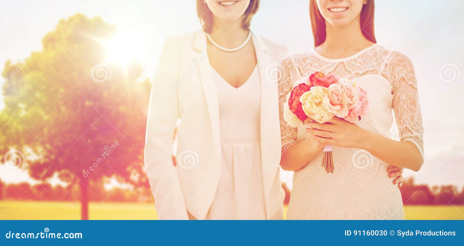 Close Up of Happy Lesbian Couple with Flowers Stock Photo