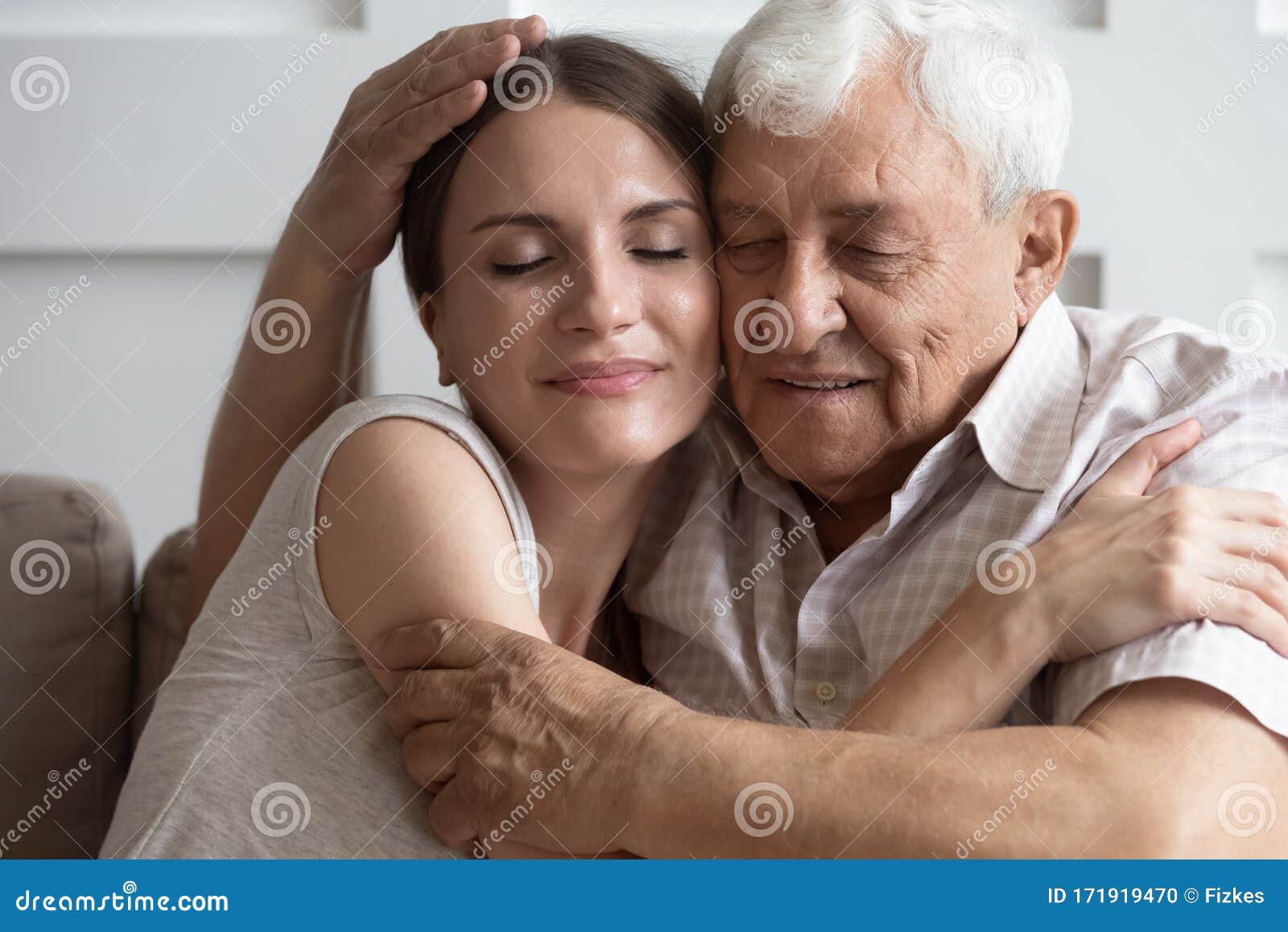 loving mature dad and daughter cuddle at home together