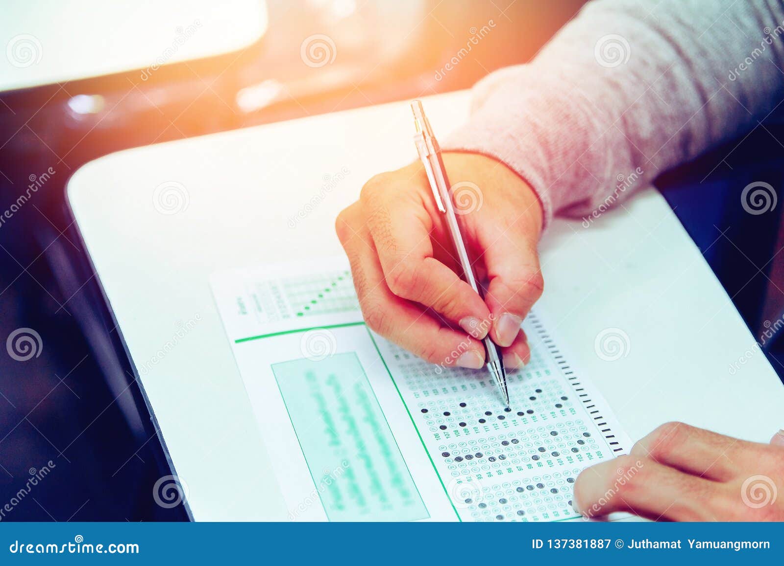 close up , high school male student holding pencil exams writing in classroom for education test ,copy space for your text.