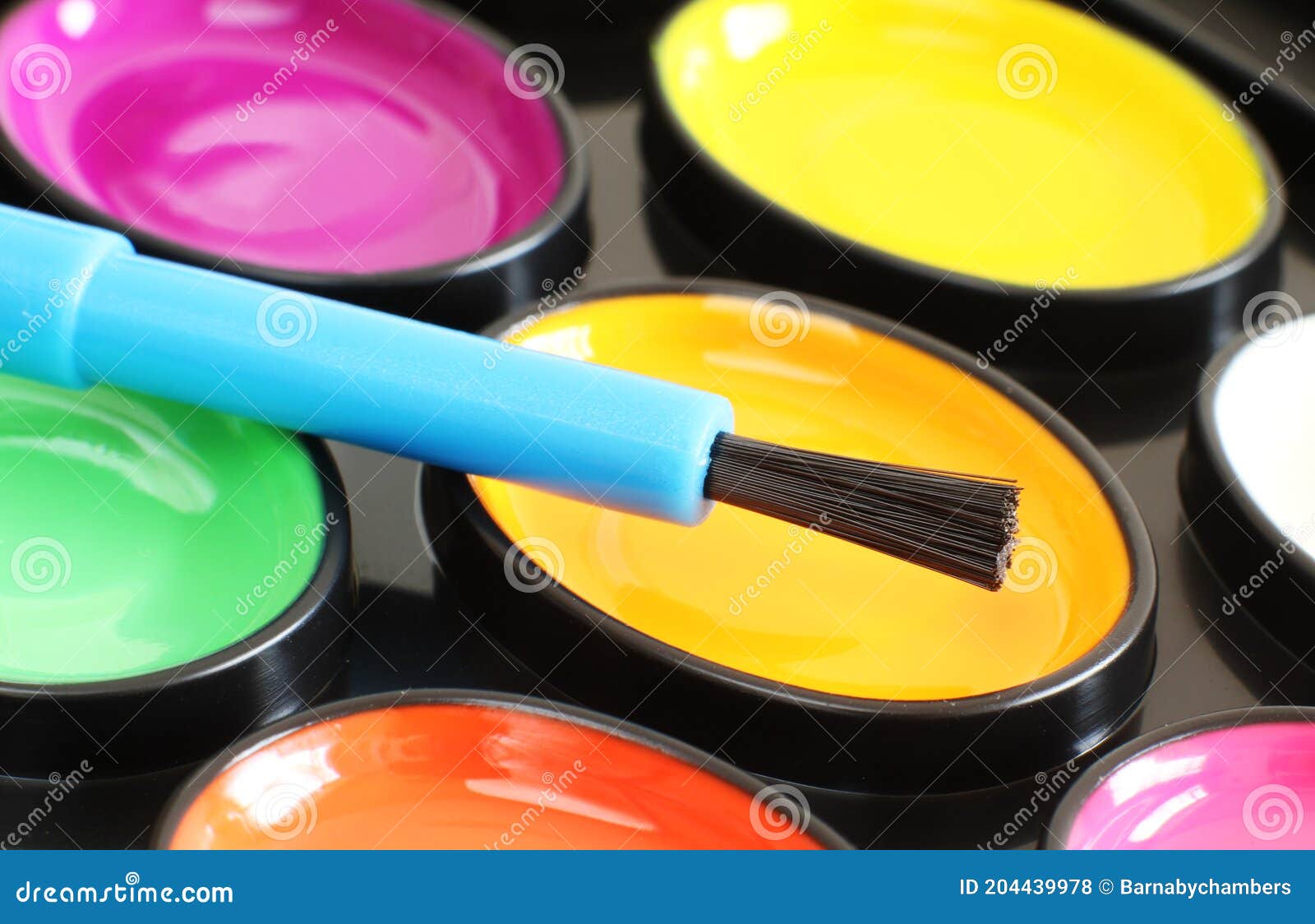 brightly coloured paint and pencils