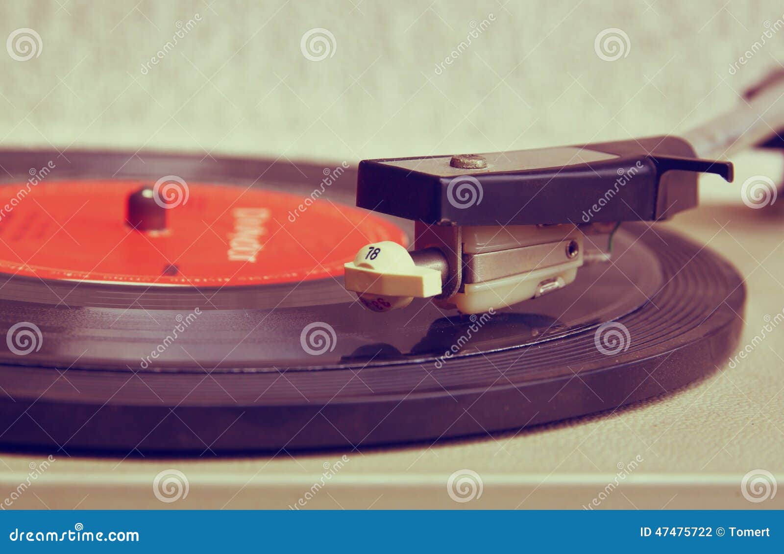 close up image of old record player, image is retro filtered . selective focus