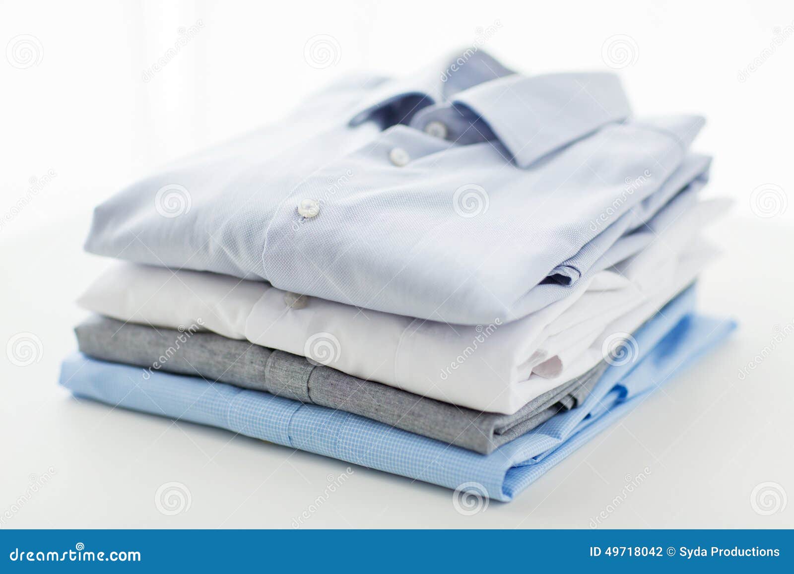 close up of ironed and folded shirts on table