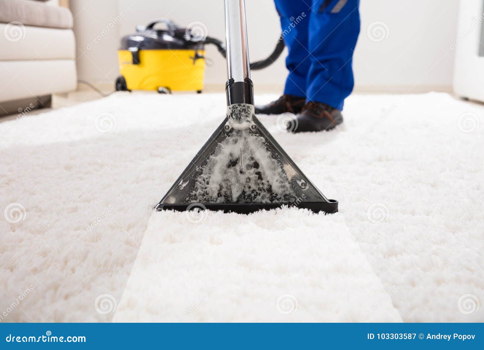 janitor cleaning carpet with vacuum cleaner